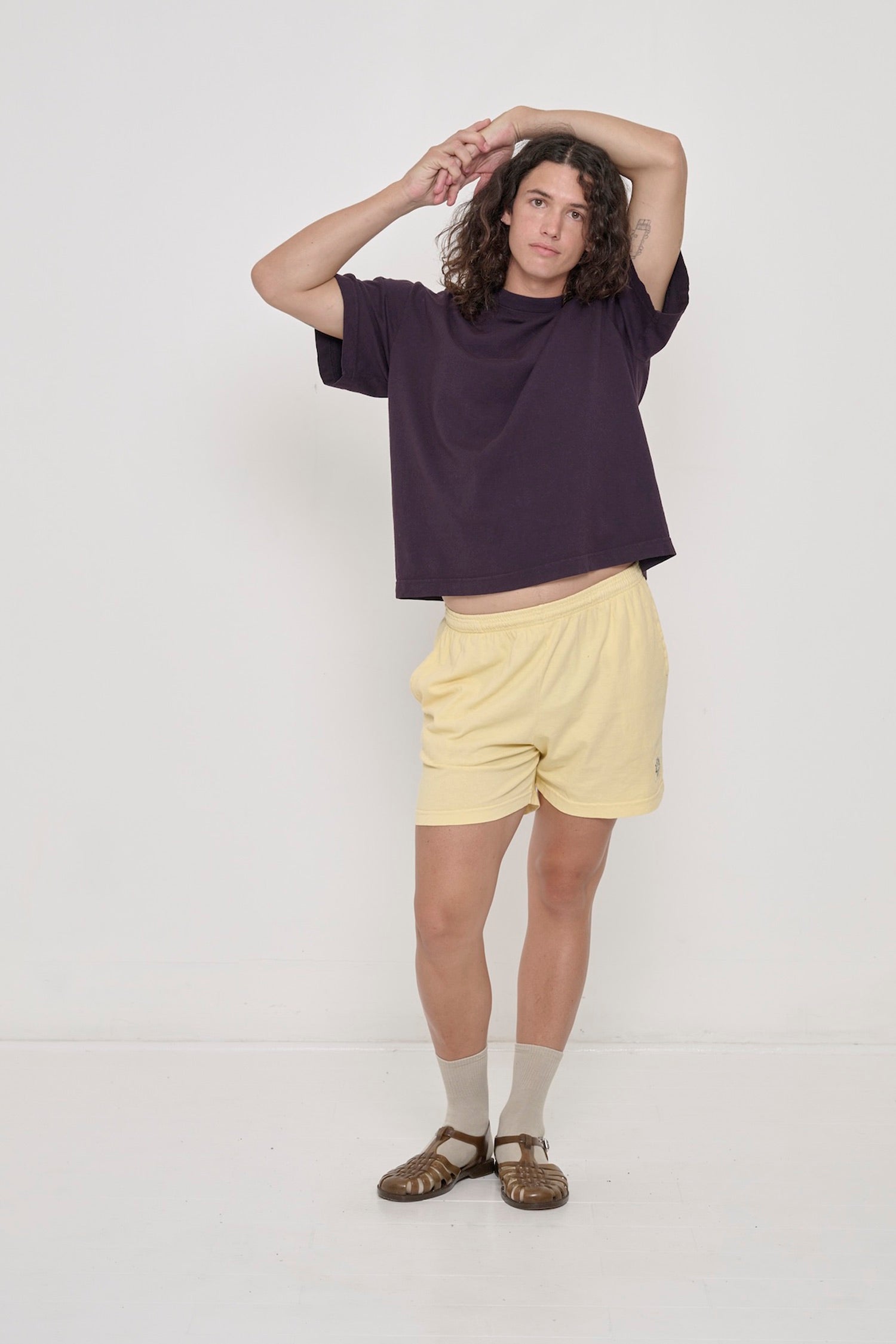 Person wearing Mulberry dark purple Boxier Trash Tee with French Butter Everyday Shorts.