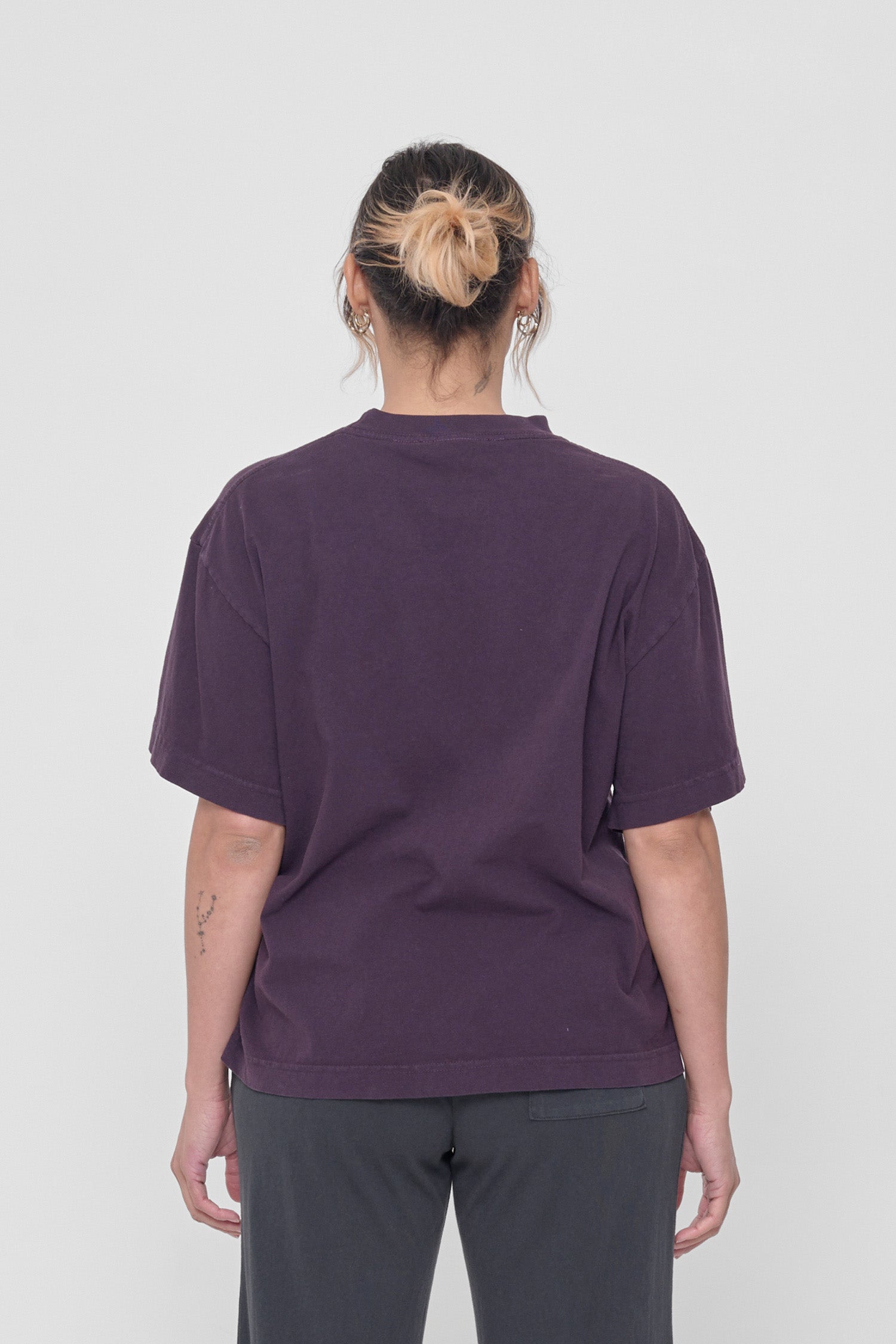 Back view showing fabric drape and relaxed fit throughout. 