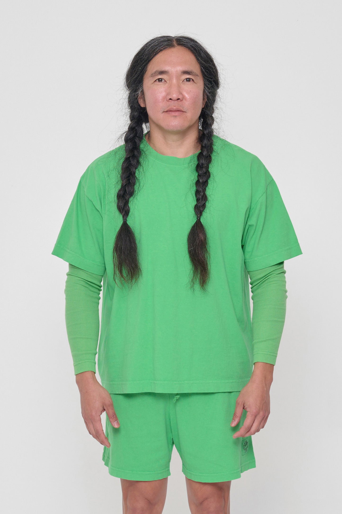 A 5'11" man in a size L Nice Grass green Boxier Trash Tee. Bottom hem at the lower hip.