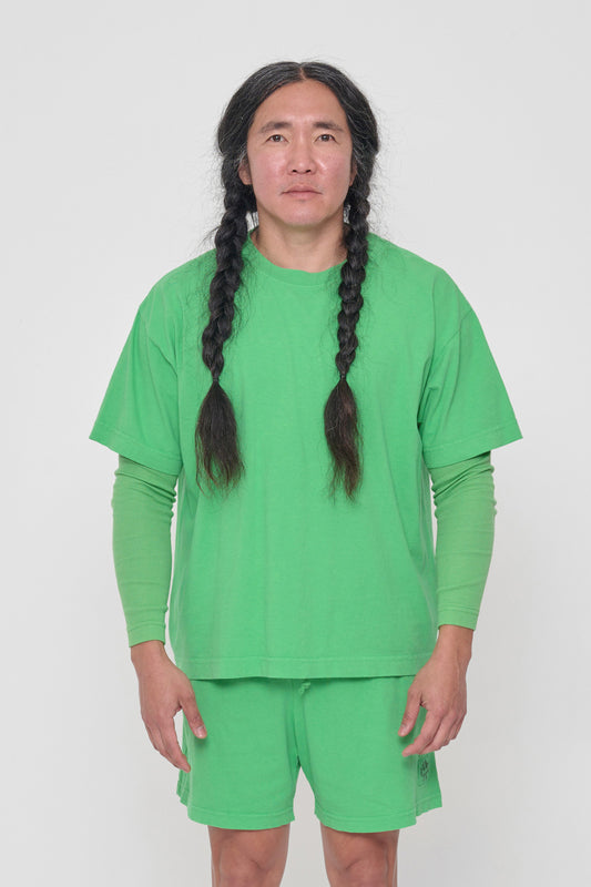 A 5'11" man in a size L Nice Grass green Boxier Trash Tee. Bottom hem at the lower hip.