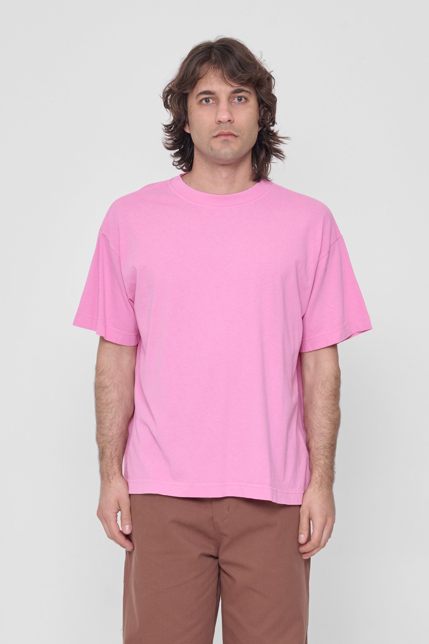 A 6'2" man in a size L Pixie pink Boxier Trash Tee. Bottom hem at lower-middle hip.