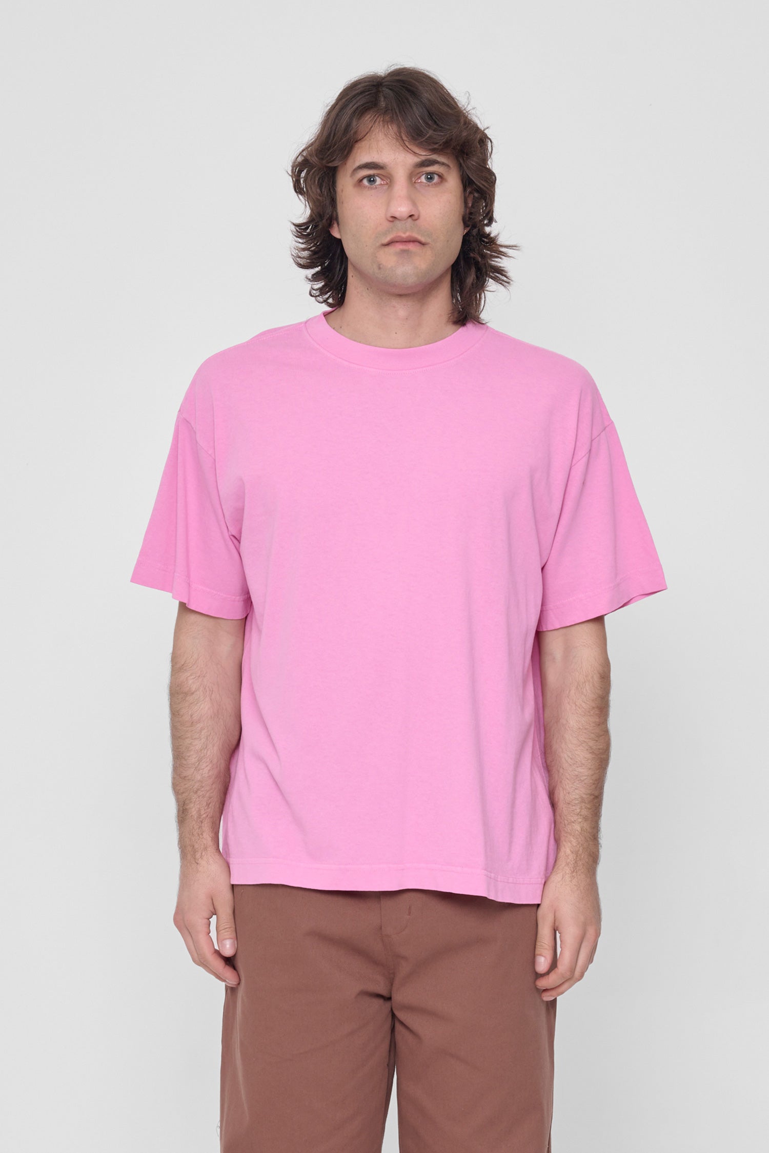 A 6'2" man in a size L Pixie pink Boxier Trash Tee. Bottom hem at lower-middle hip.