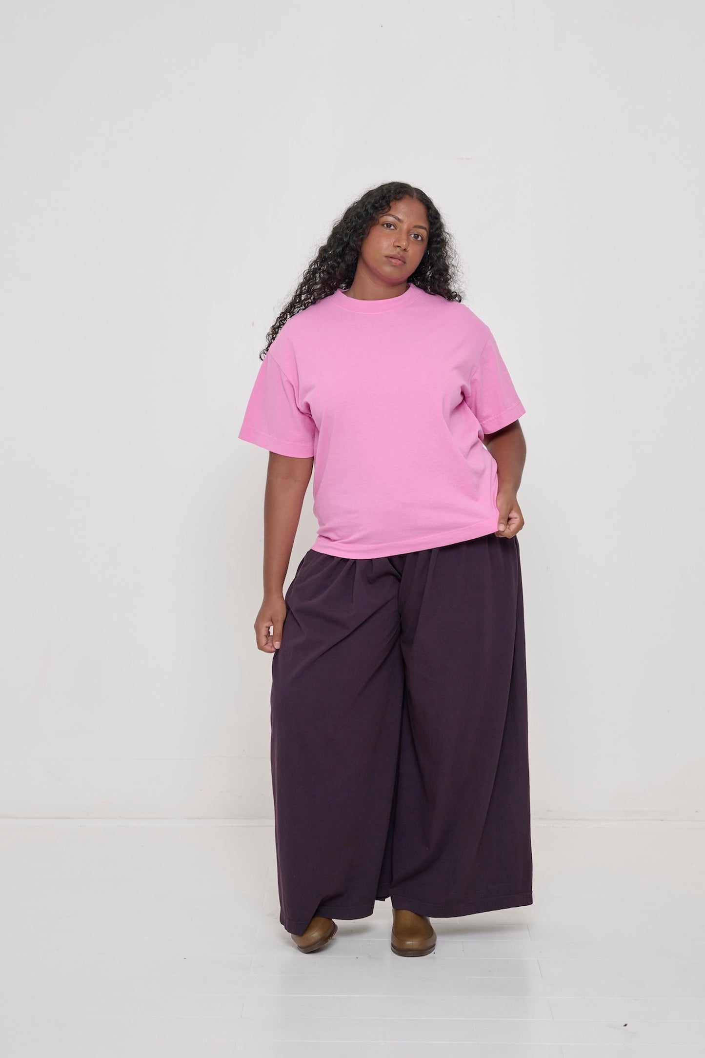 Woman wearing Pixie light pink Boxier Trash Tee and Mulberry Tubular Pants. 