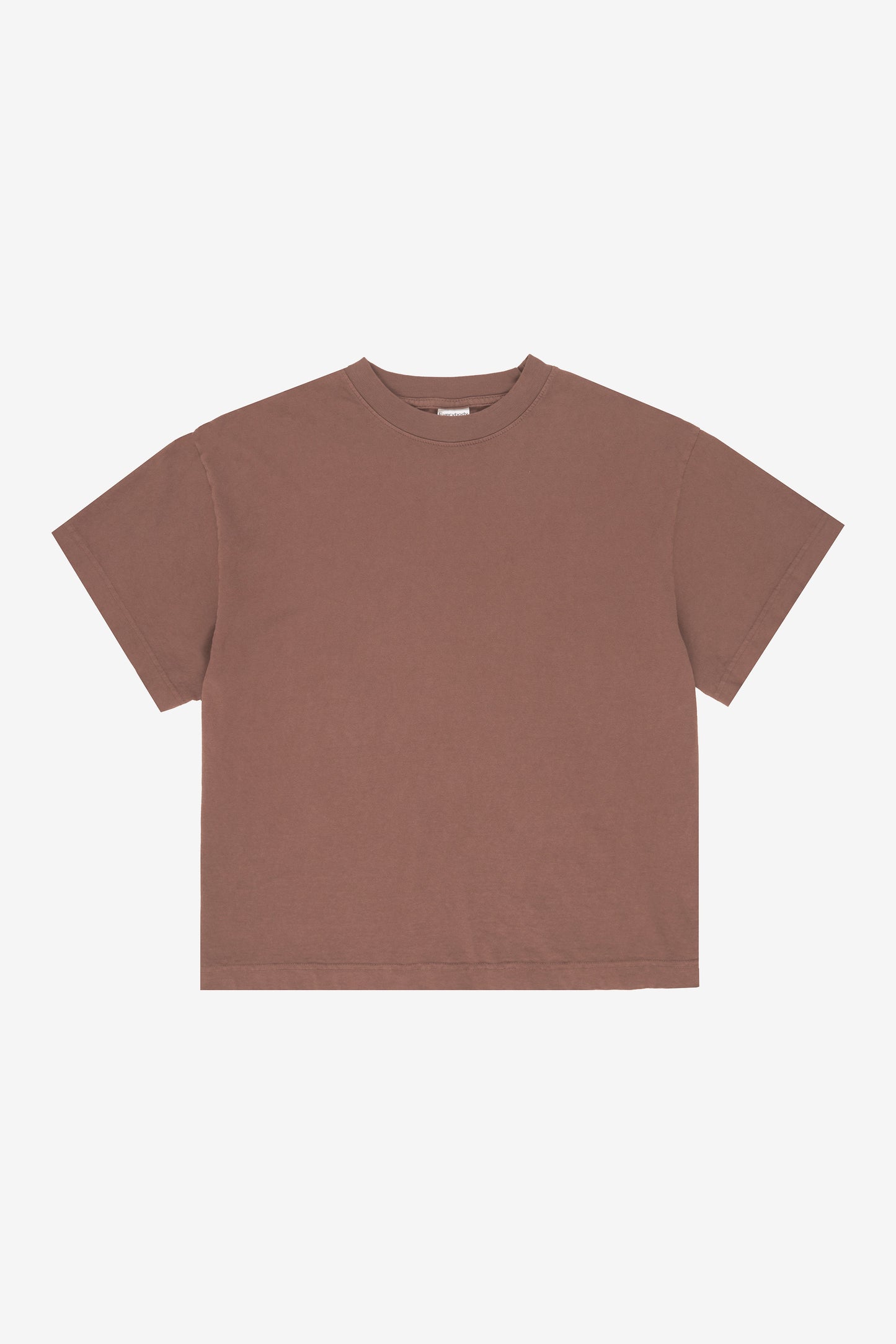 Flat lay showing the square-like boxy cut of the t-shirt.