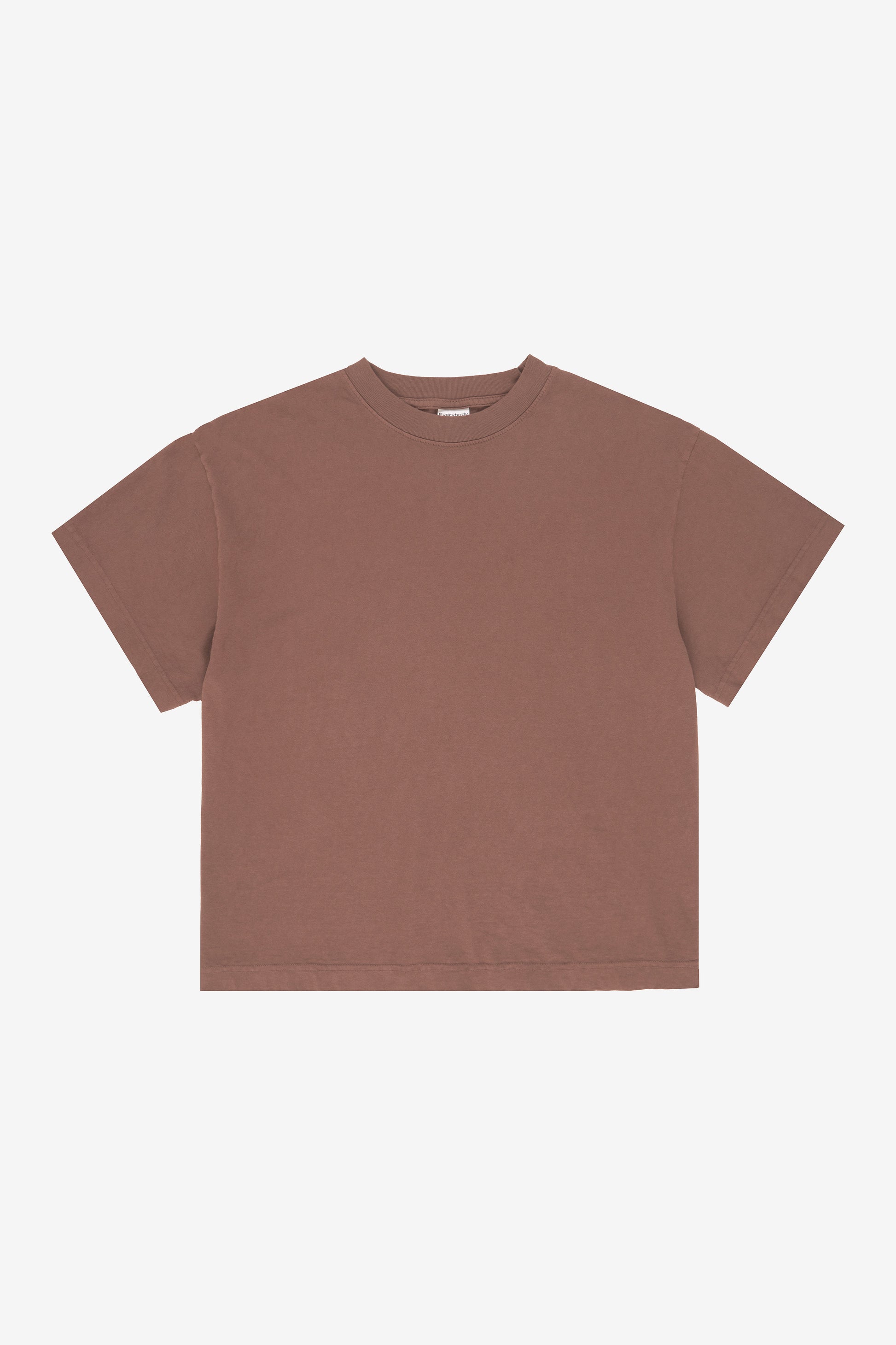 Flat lay showing the square-like boxy cut of the t-shirt.