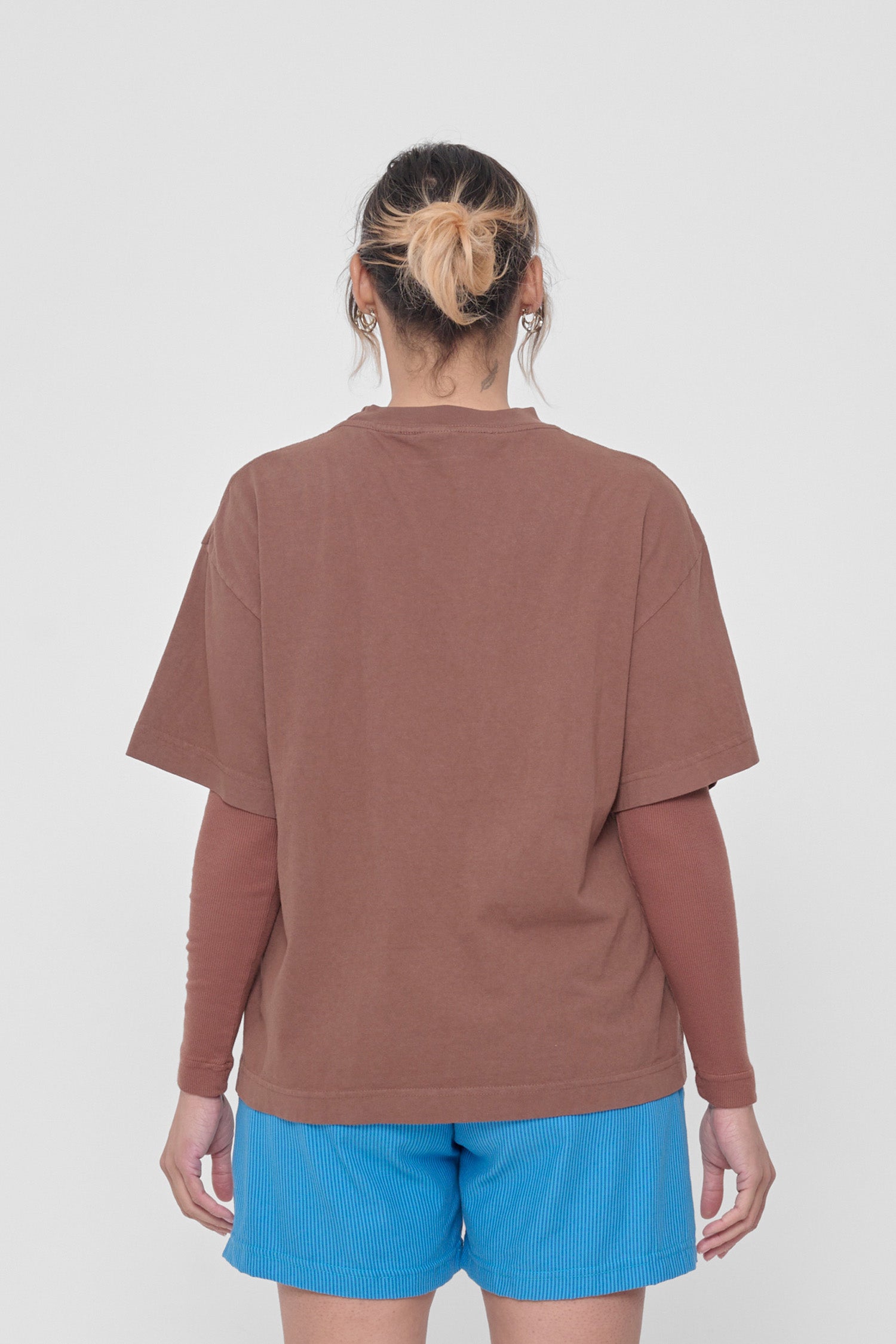 Back view showing fabric drape and relaxed fit throughout.