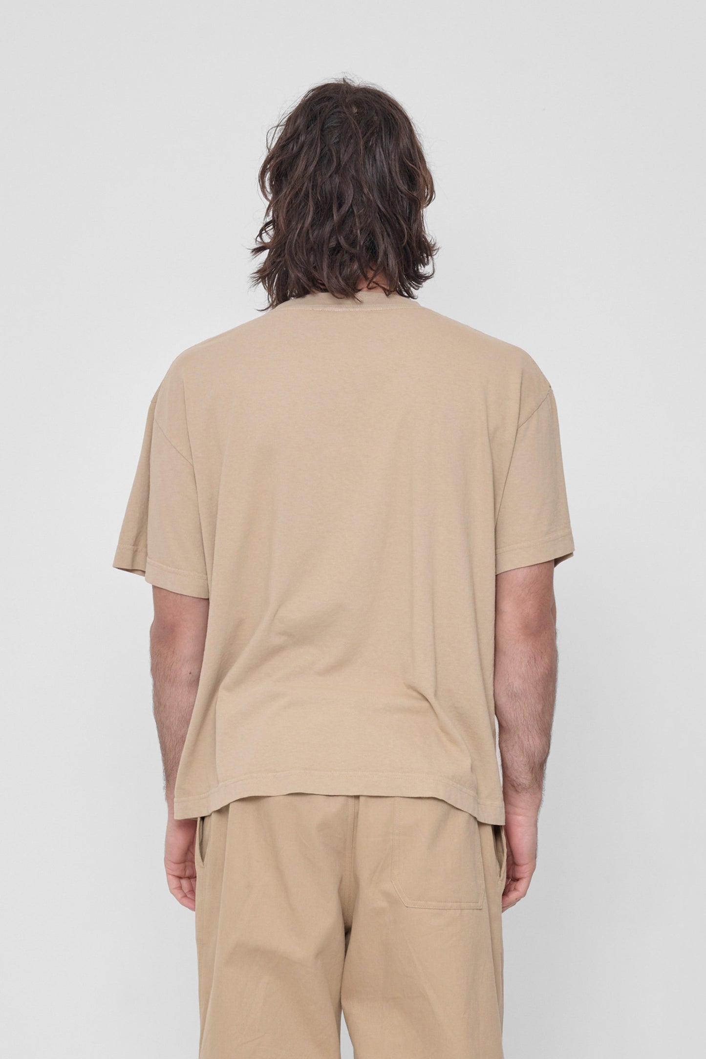 Back view showing fabric drape and relaxed fit throughout.