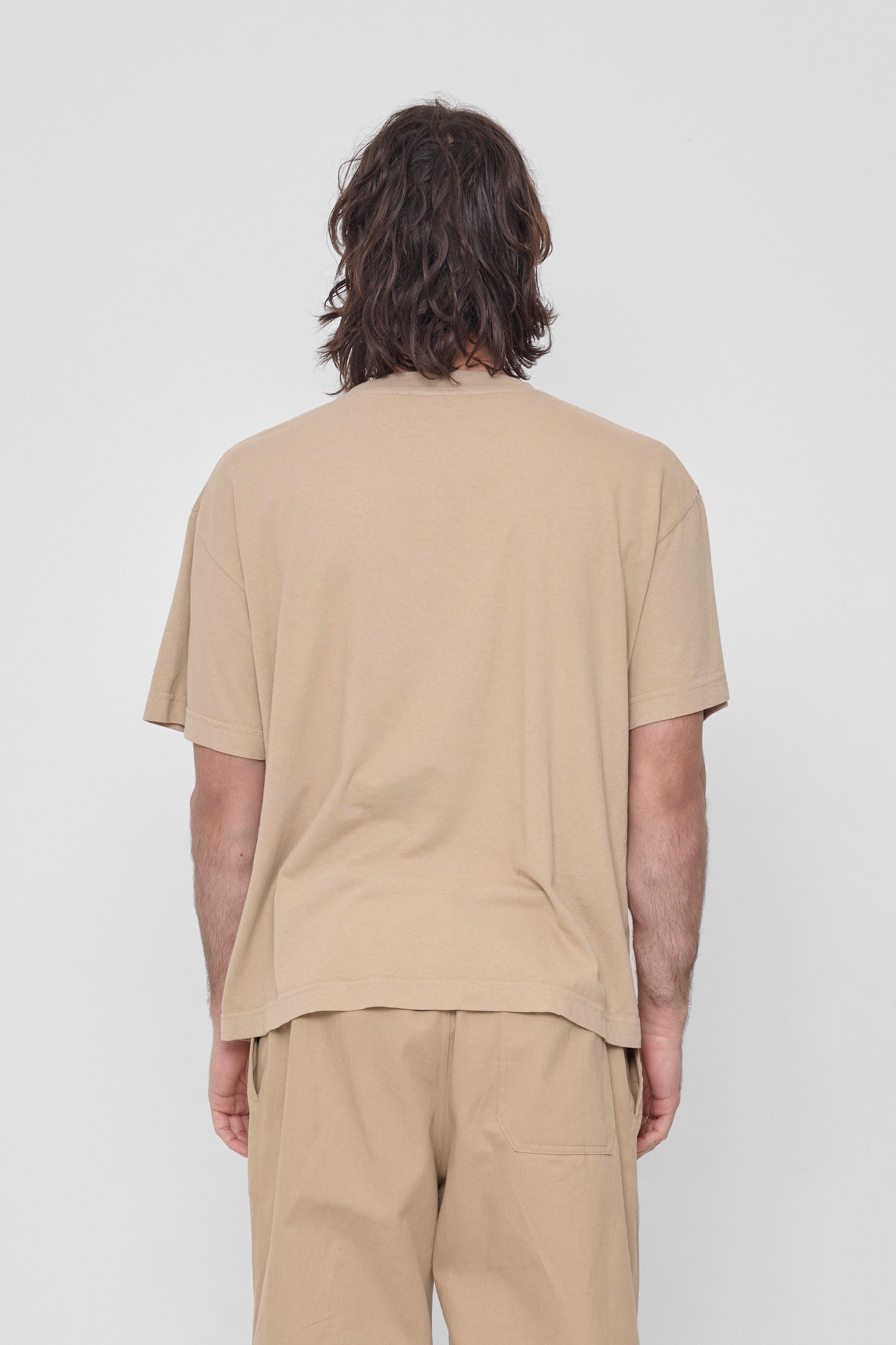 Back view showing fabric drape and relaxed fit throughout.