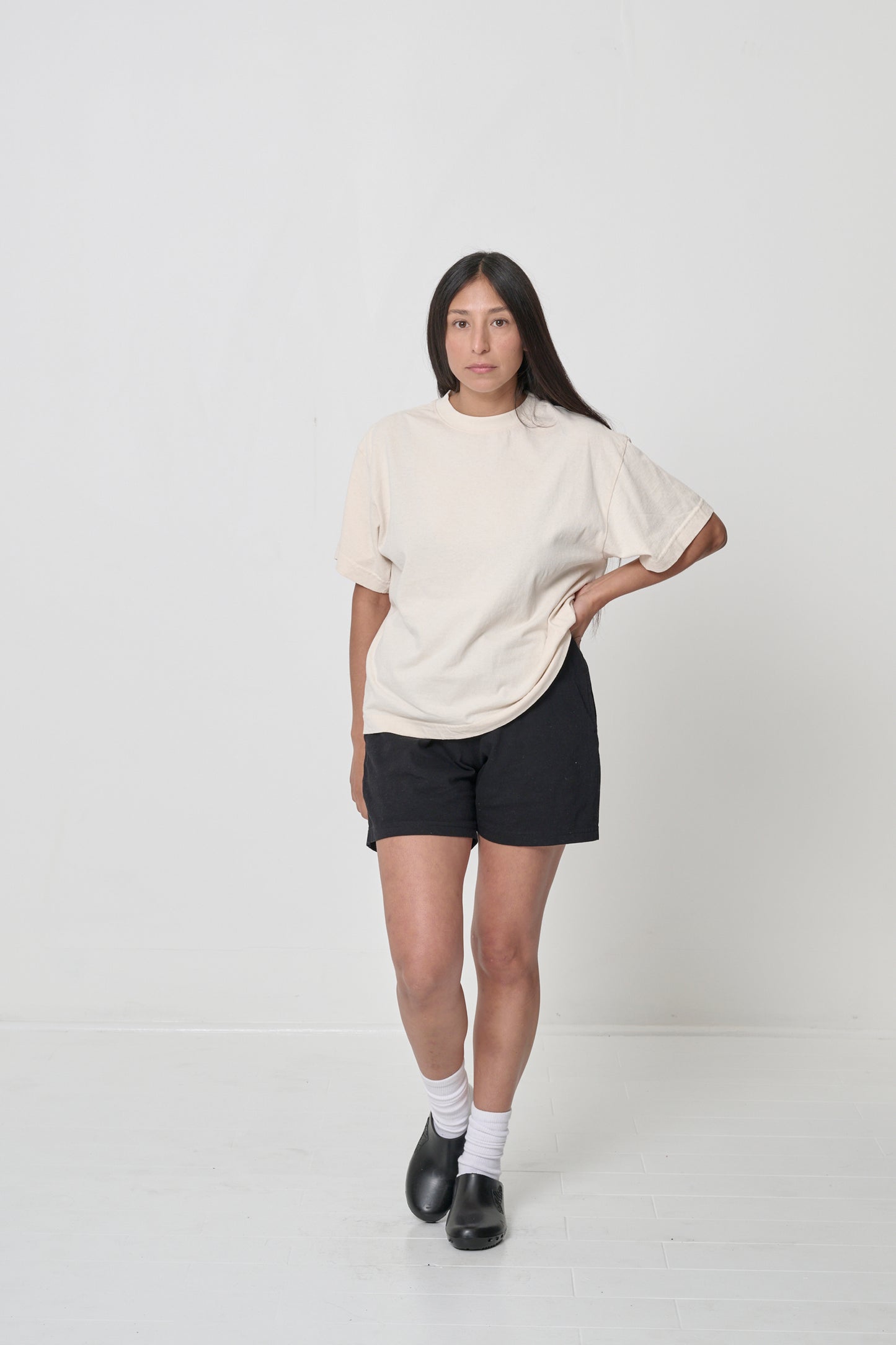 A woman wearing a Scour Boxier Trash Tee with Black Everyday Shorts showing the relaxed boxy fit.