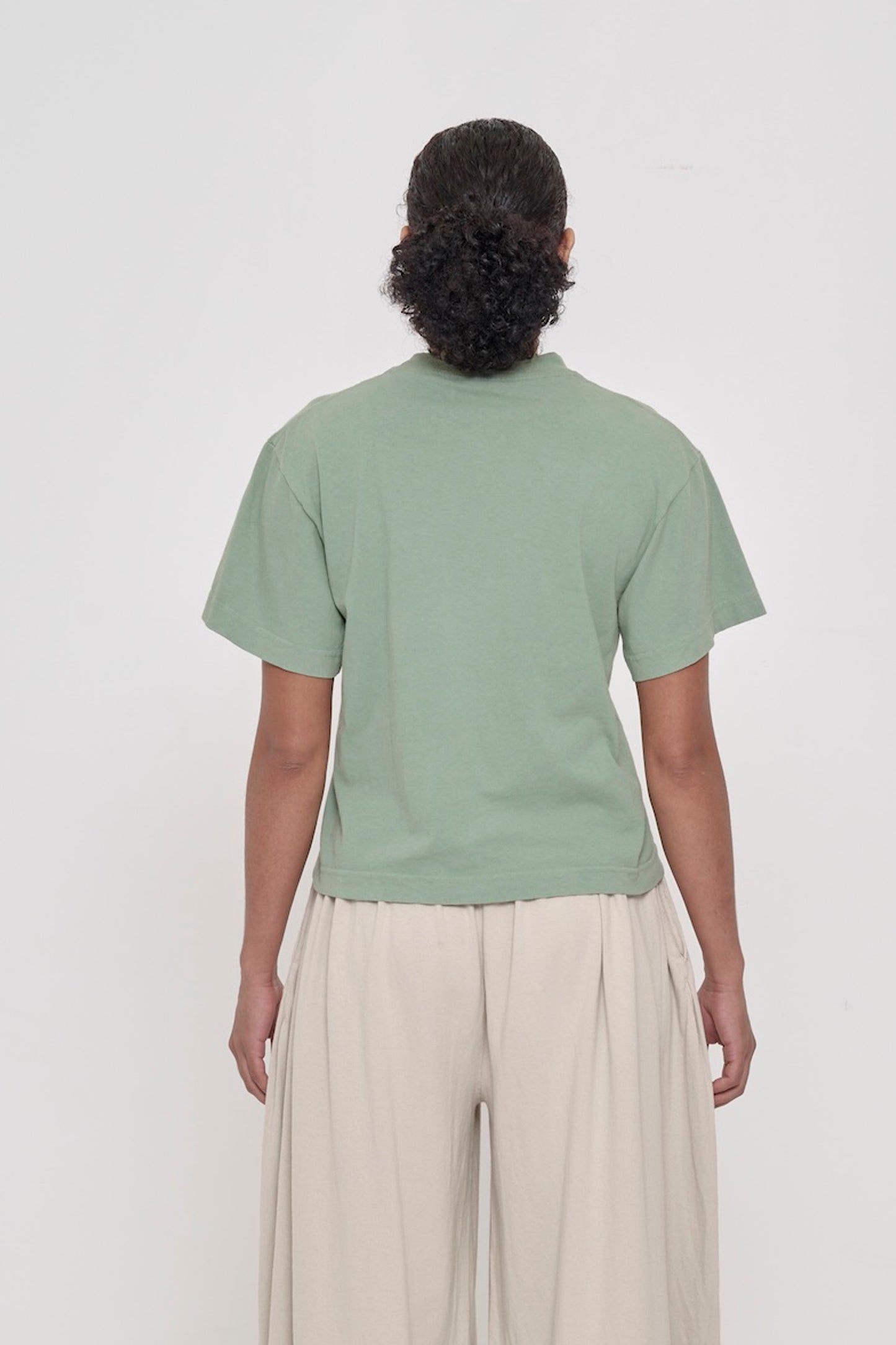 Back view of Boxier Trash Tee in Wasabi showing fabric drape and relaxed fit throughout.