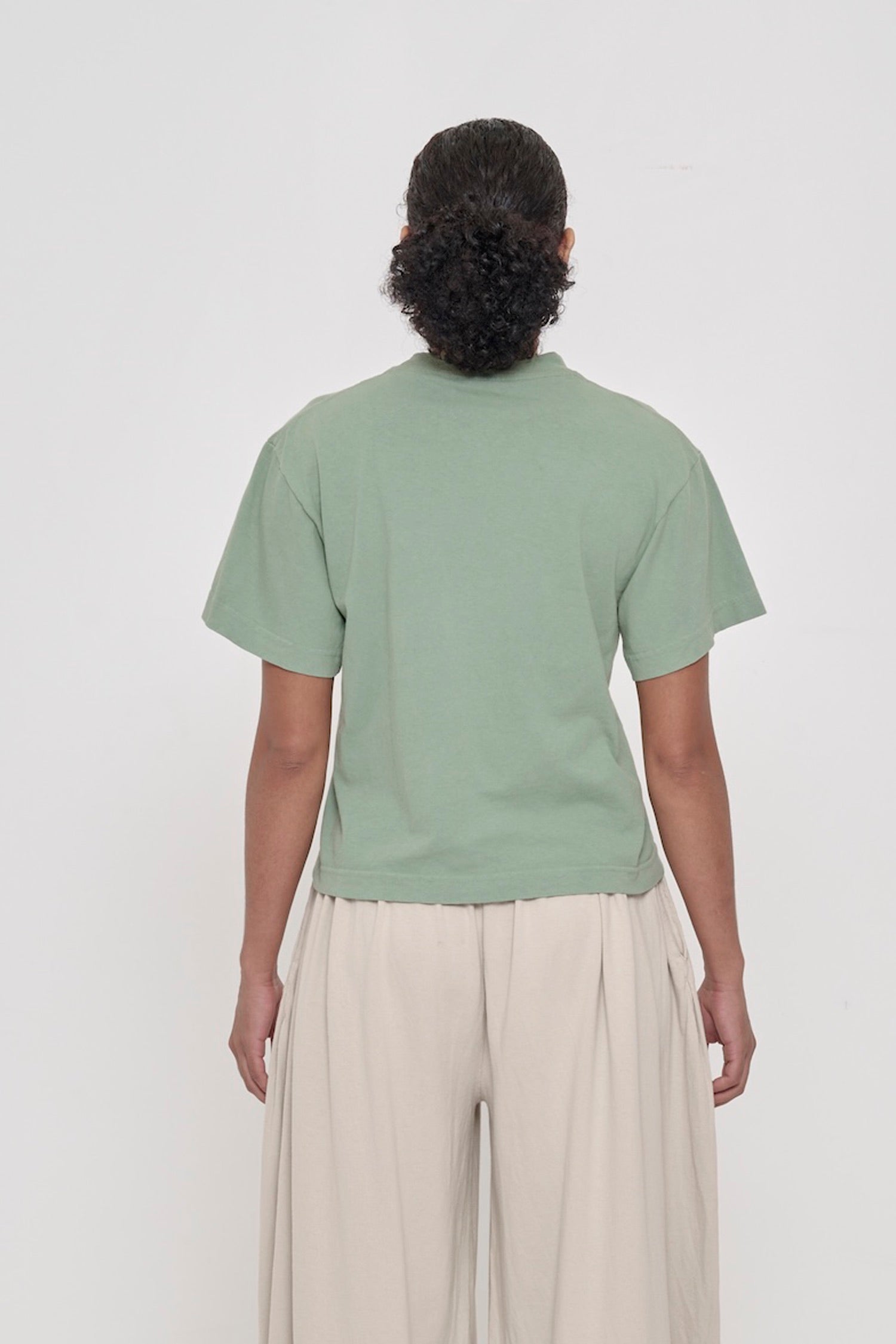 Back view of Boxier Trash Tee in Wasabi showing fabric drape and relaxed fit throughout.
