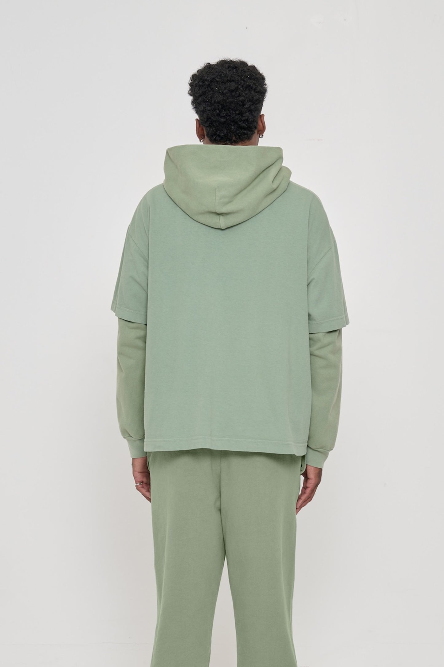 Back view of Boxier Trash Tee in Wasabi showing fabric drape and relaxed fit throughout.
