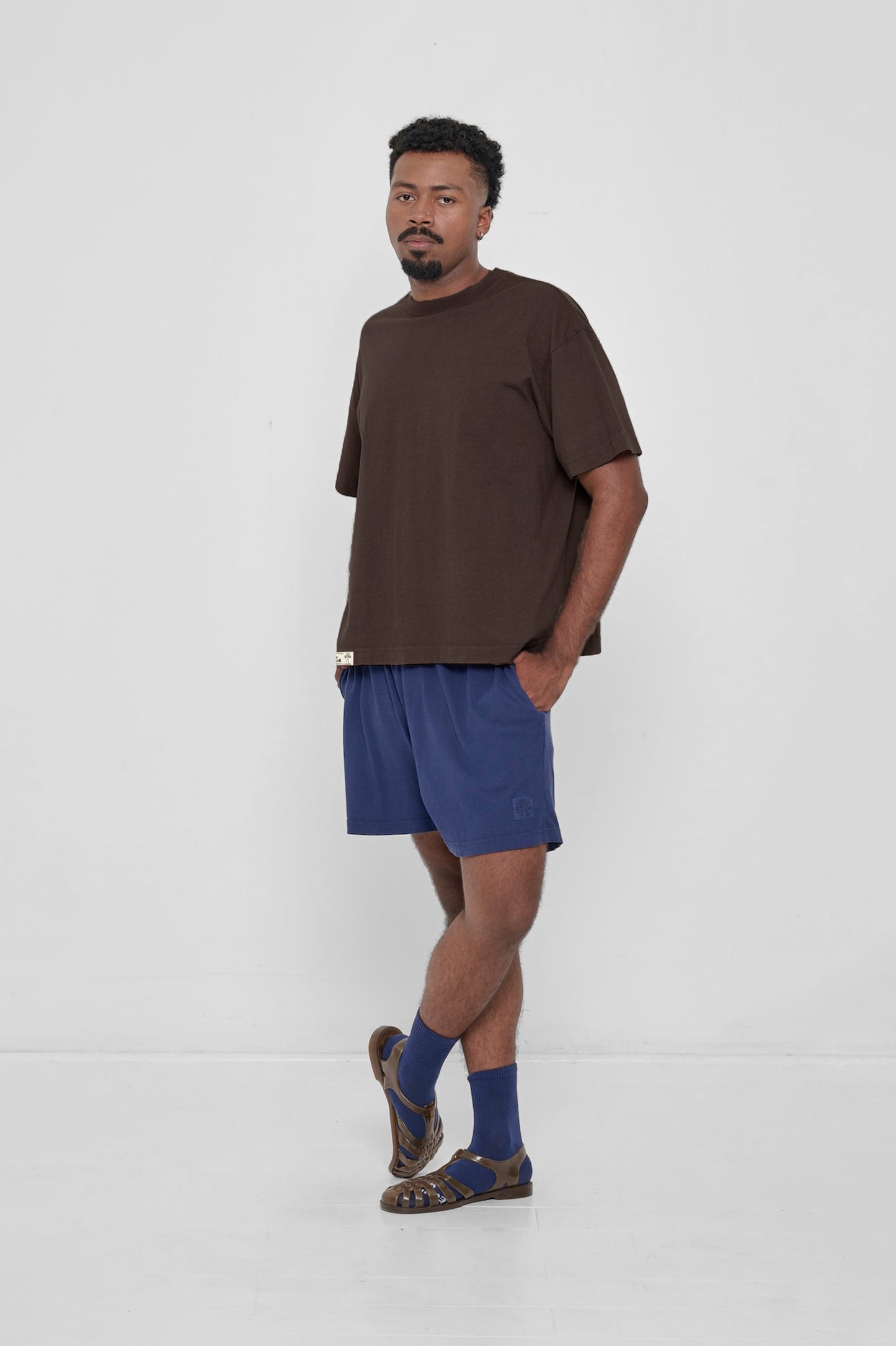 Hands in pockets and wearing Washed Navy Everyday Shorts. 