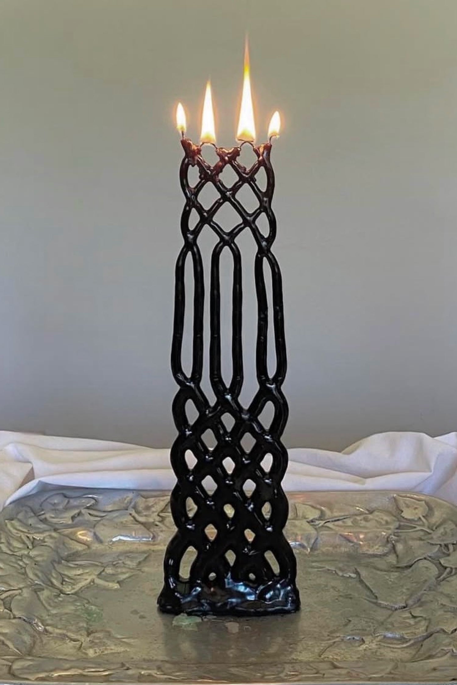Slate lattice-patterned candle on a silver platter