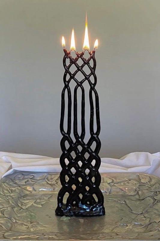 Slate lattice-patterned candle on a silver platter