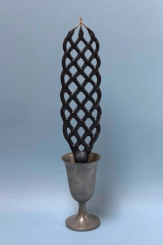 Slate lattice-patterned candle on a gray background