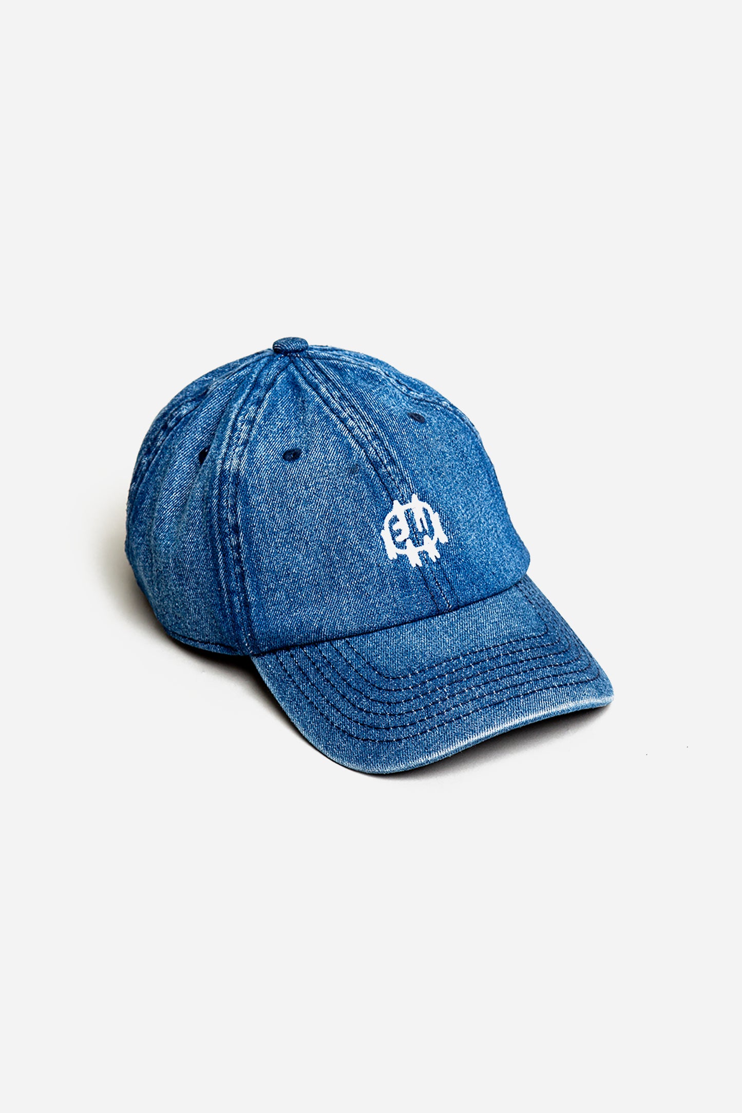 Bucky Logo Cap in Denim blue with a white logo, on a white background. Details show eyelets on hat panels and stitching on bill.