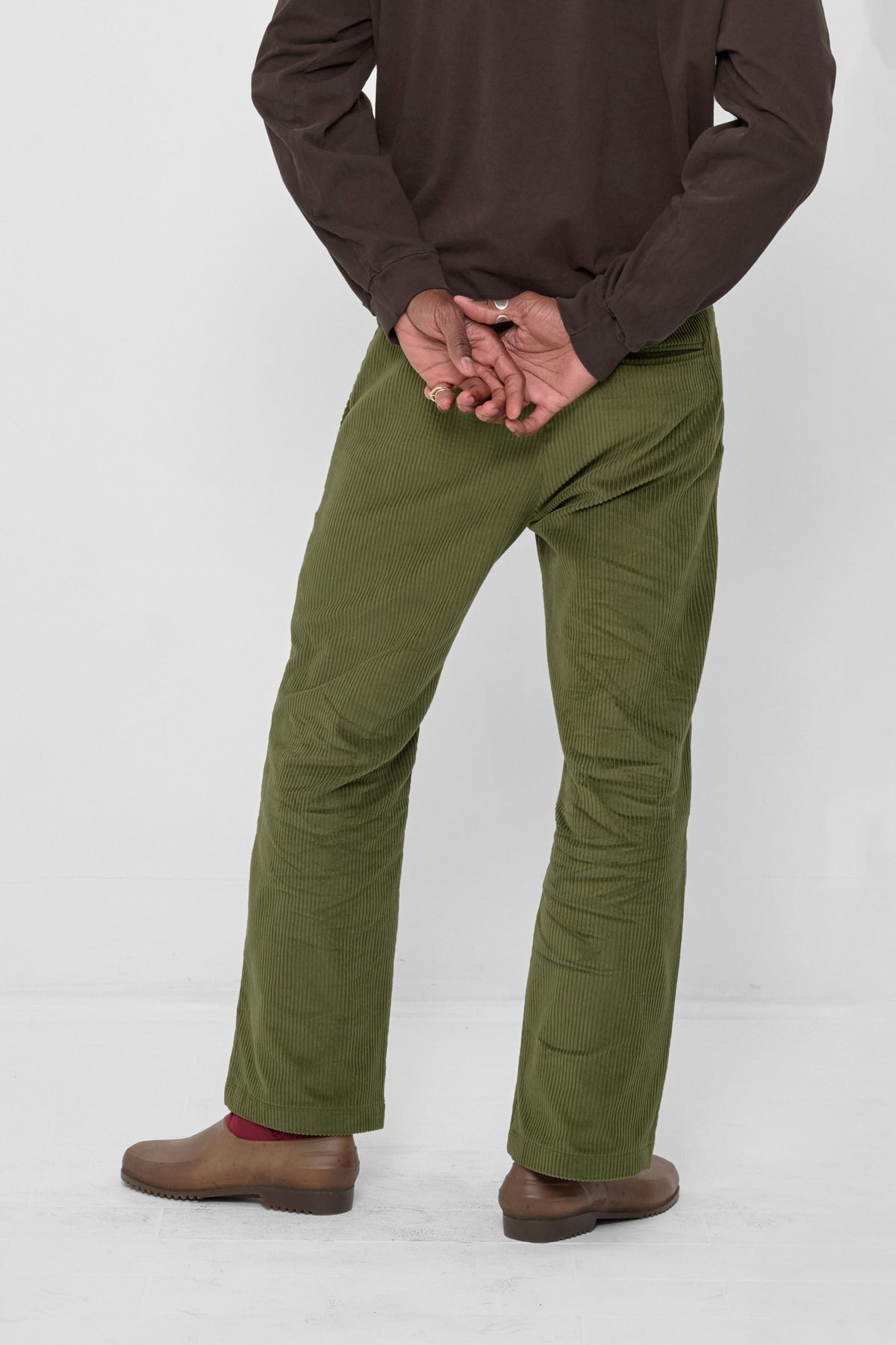Cord Pants in Olive – back view on model