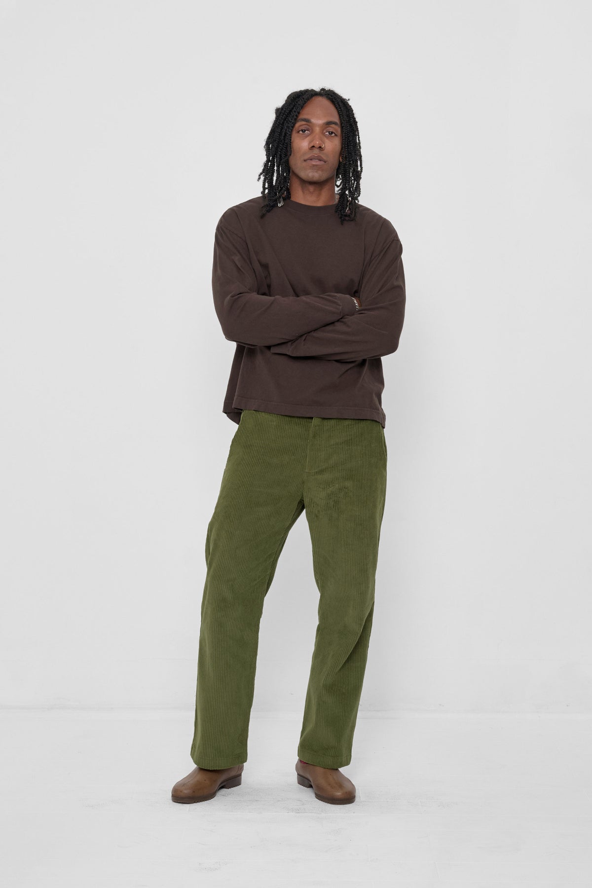 Cord Pants in Olive – front view on model, styled with Wet Soil Long Sleeve Boxier Trash tee