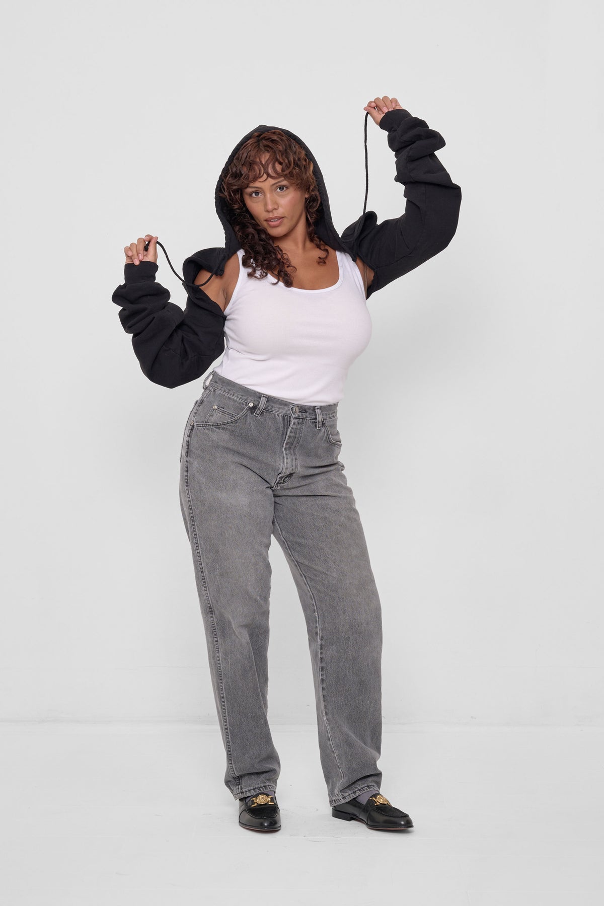 Clyde x Everybody.World Hoodie Scarf in Black – front view, styled with White Tank, Grey Jeans, and loafers