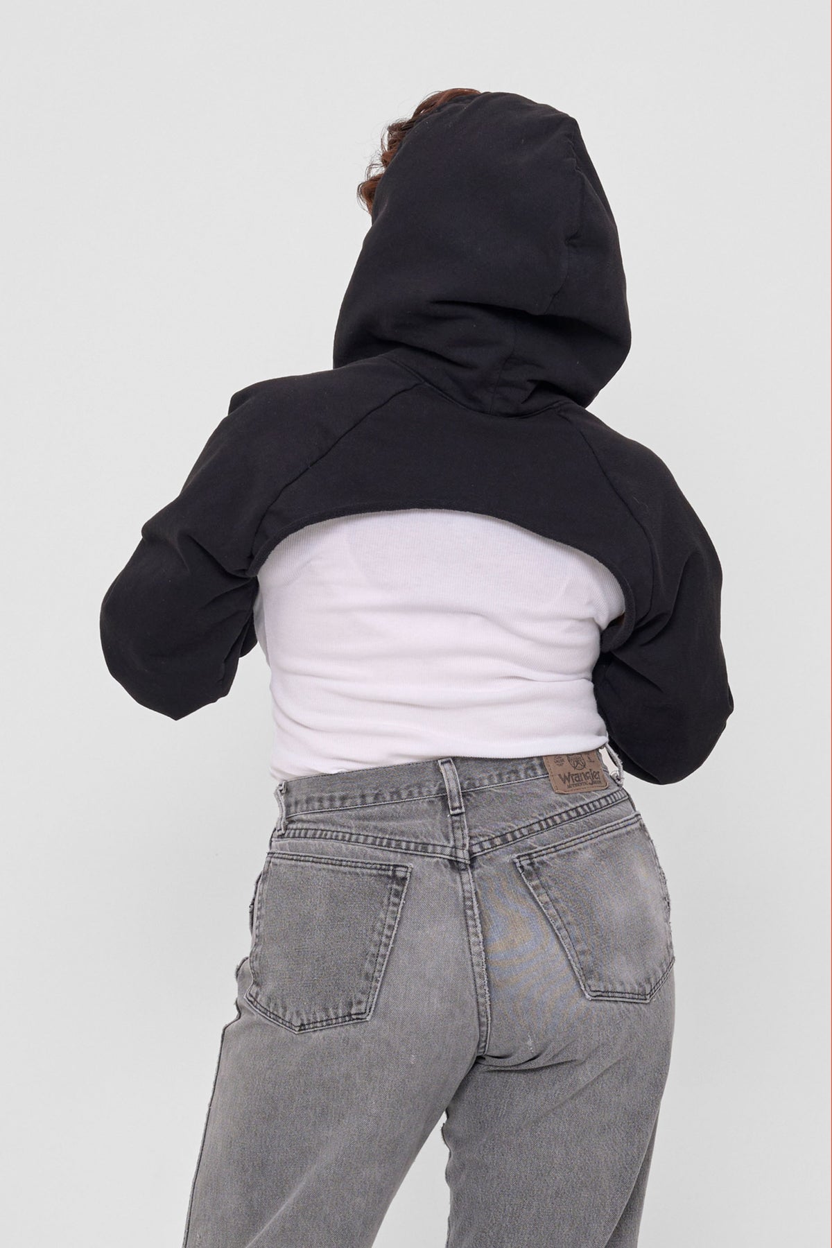 Clyde x Everybody.World Hoodie Scarf in Black – back view on model, hood up and arms through sleeves