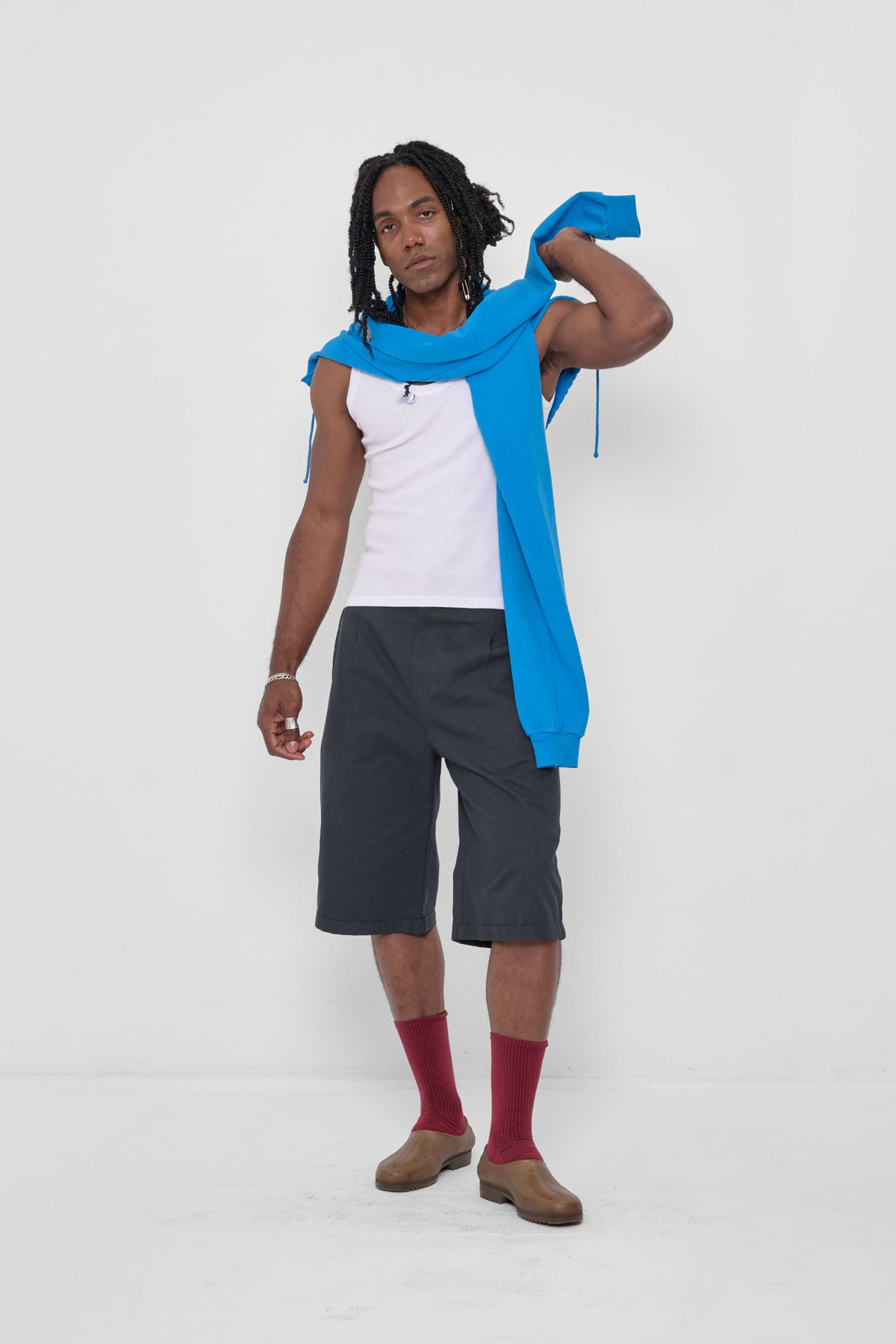 Clyde x Everybody.World Hoodie Scarf in Malibu – front view, styled with Slate Bermuda Shorts, Garnet Squishy Socks, and Plasticana Gardana Clogs