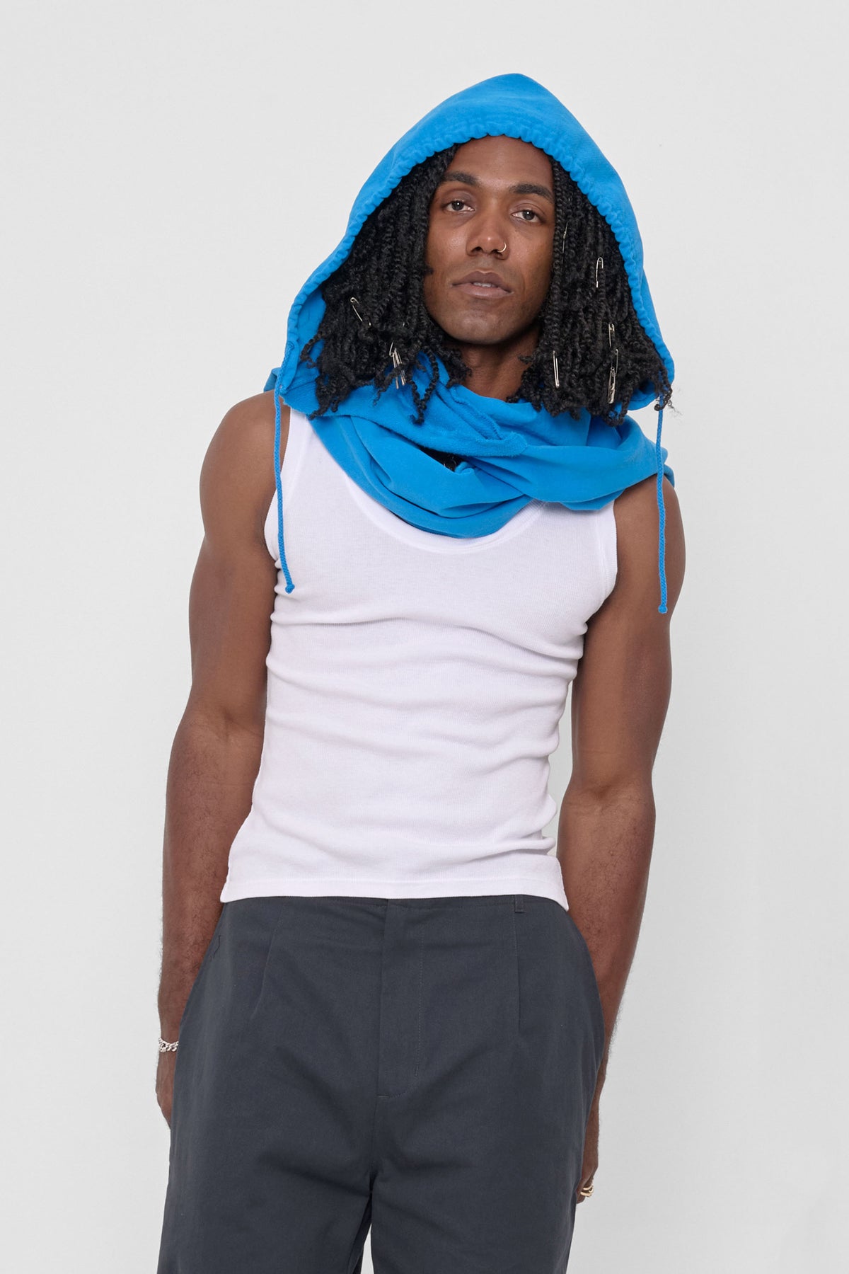 Clyde x Everybody.World Hoodie Scarf in Malibu – front view on model, worn with hood on and sleeves wrapped around neck