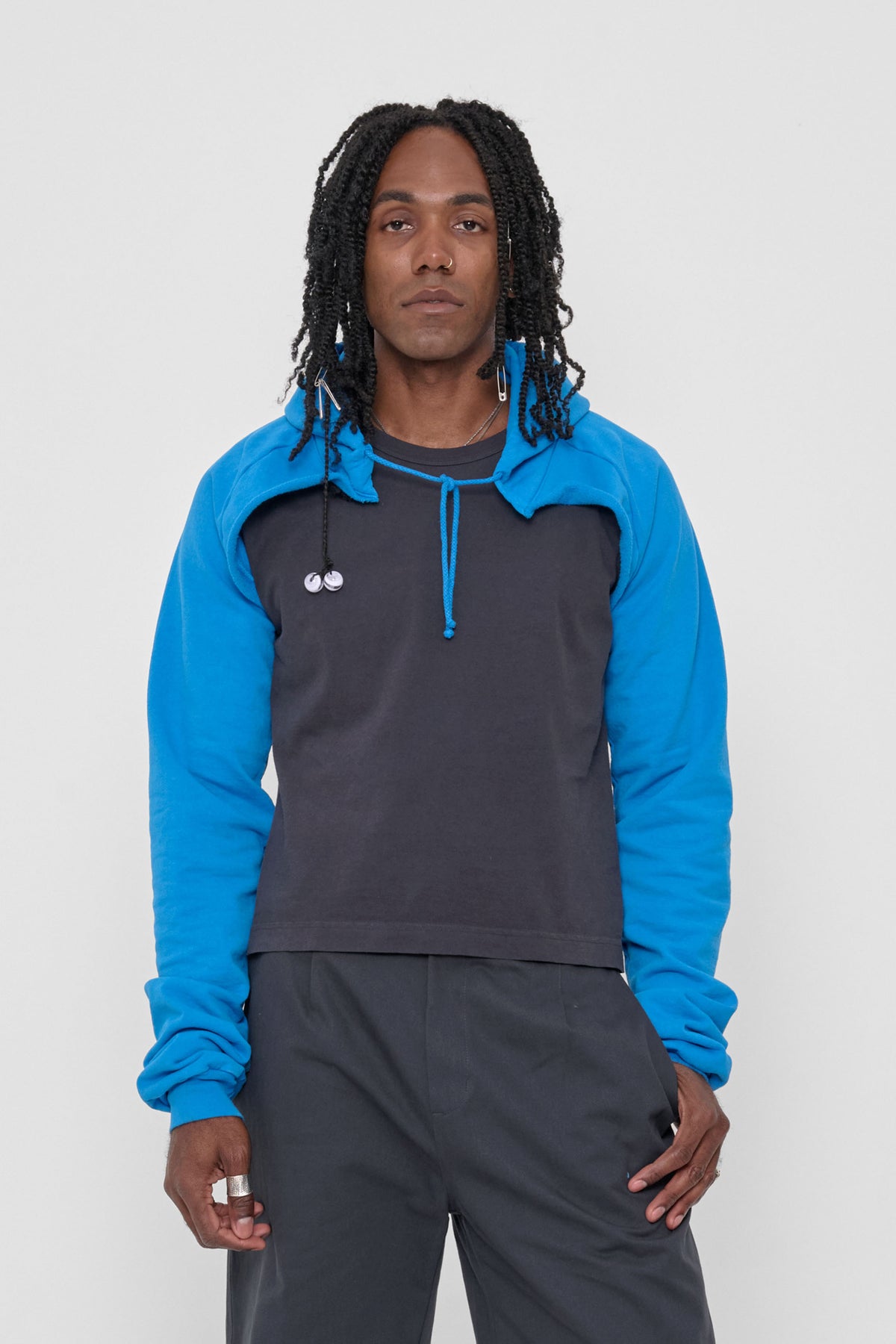 Clyde x Everybody.World Hoodie Scarf in Malibu – front view on model, worn tied, with hood down, and arms through the sleeves