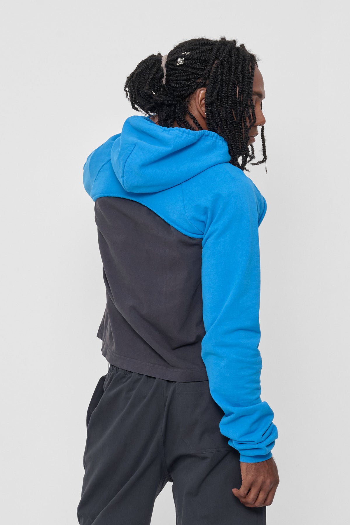 Clyde x Everybody.World Hoodie Scarf in Malibu – back view on model, hood down and arms through sleeves