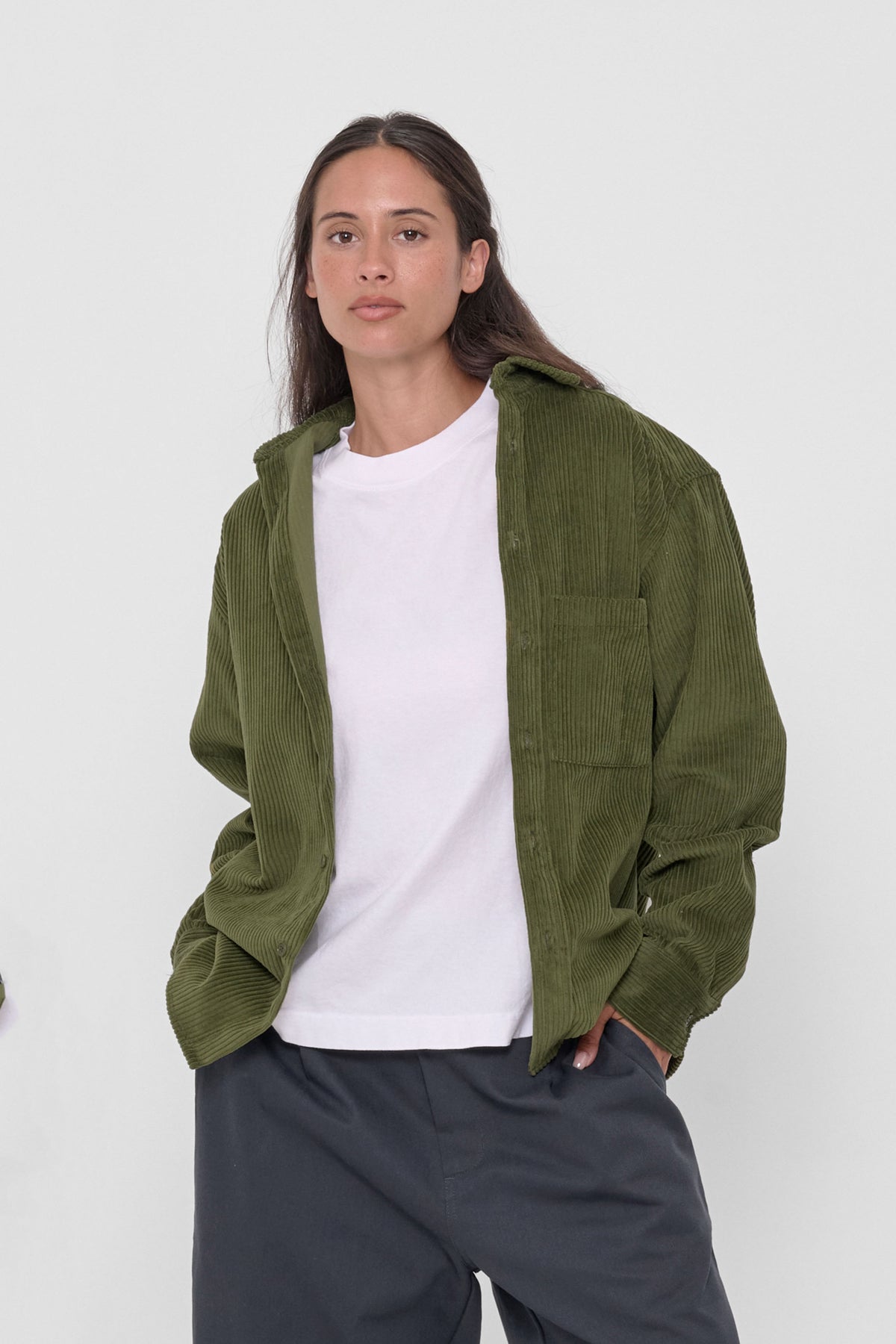 Cord Button-Up Shirt in Olive – front view on model, unbuttoned over white shirt