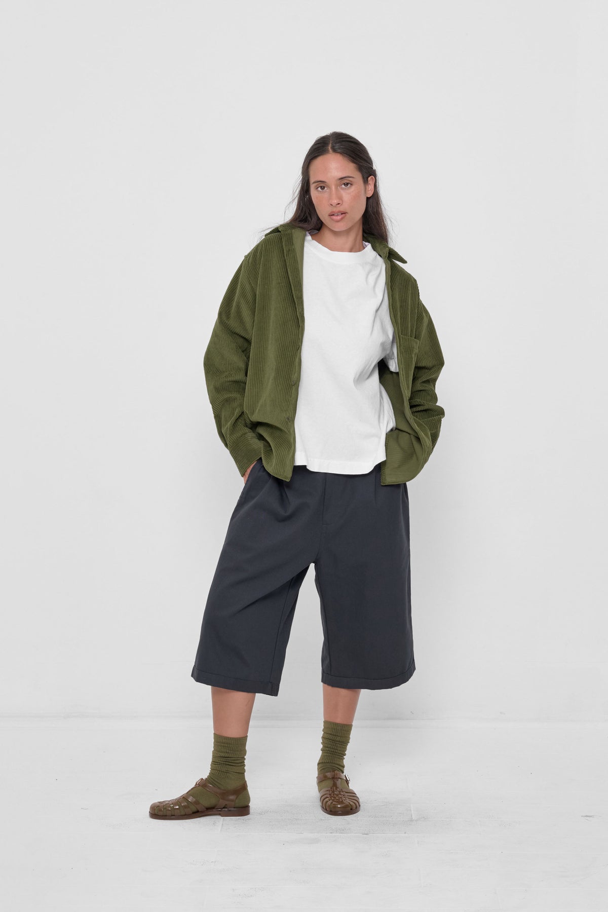 Cord Button-Up Shirt in Olive – front full body view on model, unbuttoned over white Boxier Trash Tee
