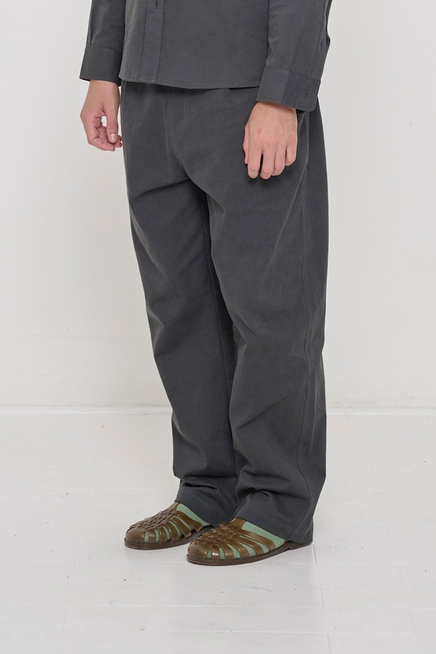 Bottom half of a person turned  45-degrees, in Slate Cotton Twill Life Uniform Pants showing the inseam and outseam.