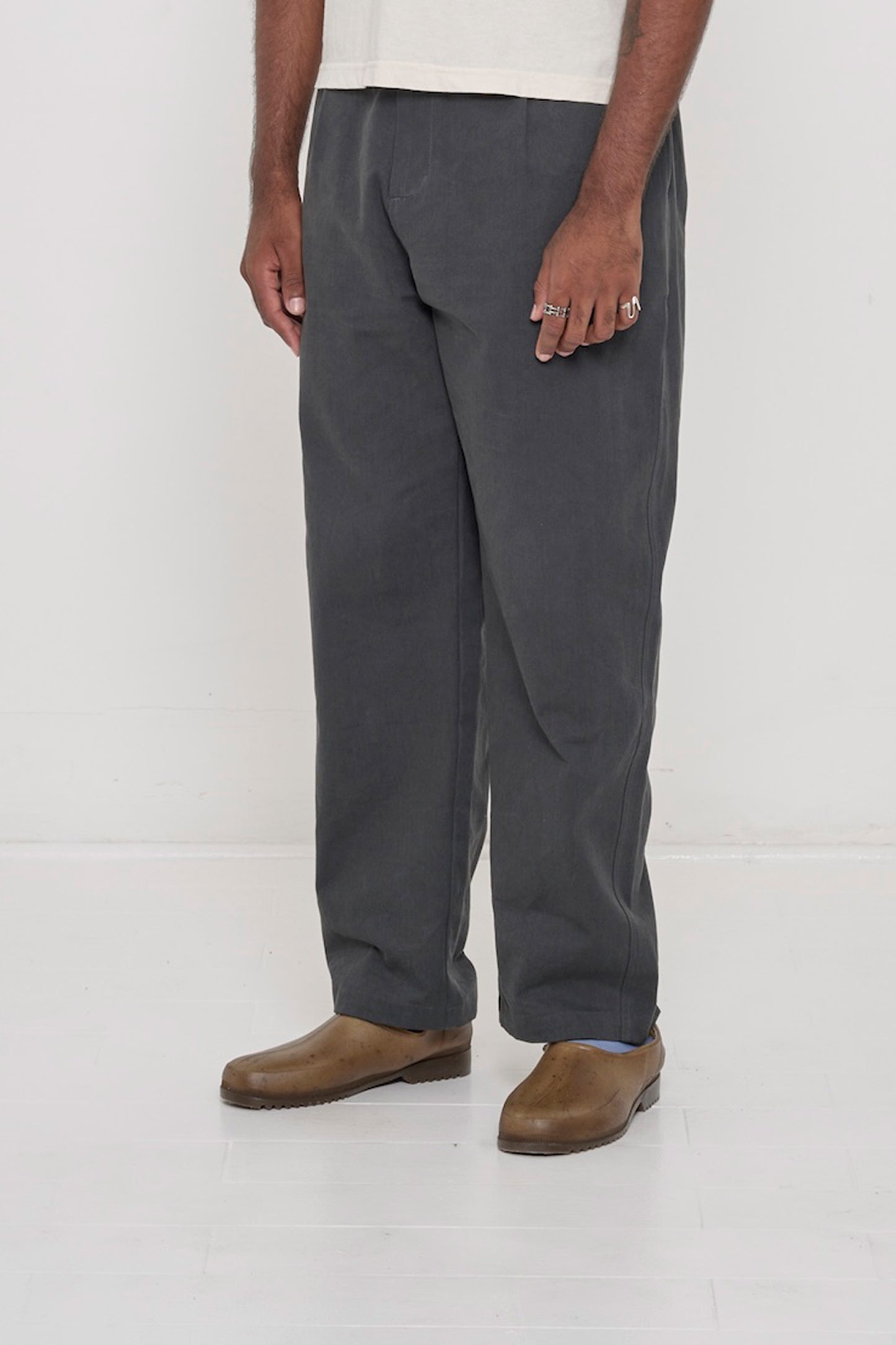 Bottom half of a man turned 45-degrees, wearing Slate Cotton Twill Life Uniform Pants showing the inseam and outseam.