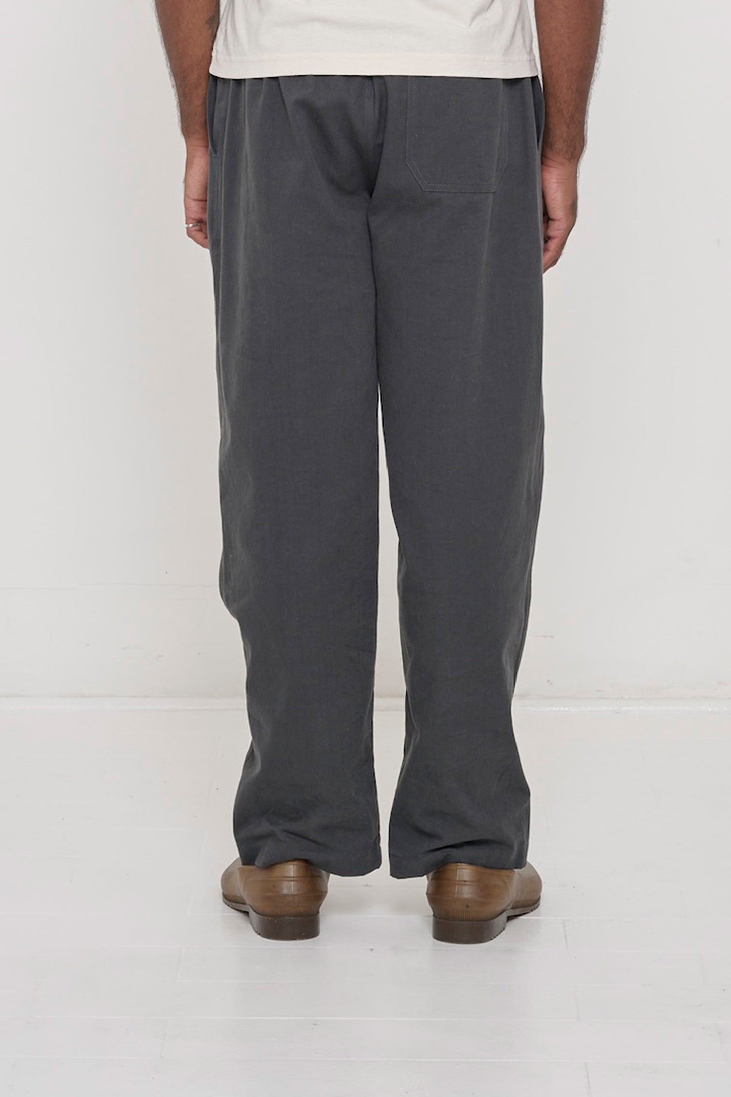 Back view: man wearing Slate Cotton Twill Life Uniform Pants showing one back pocket on the right side.
