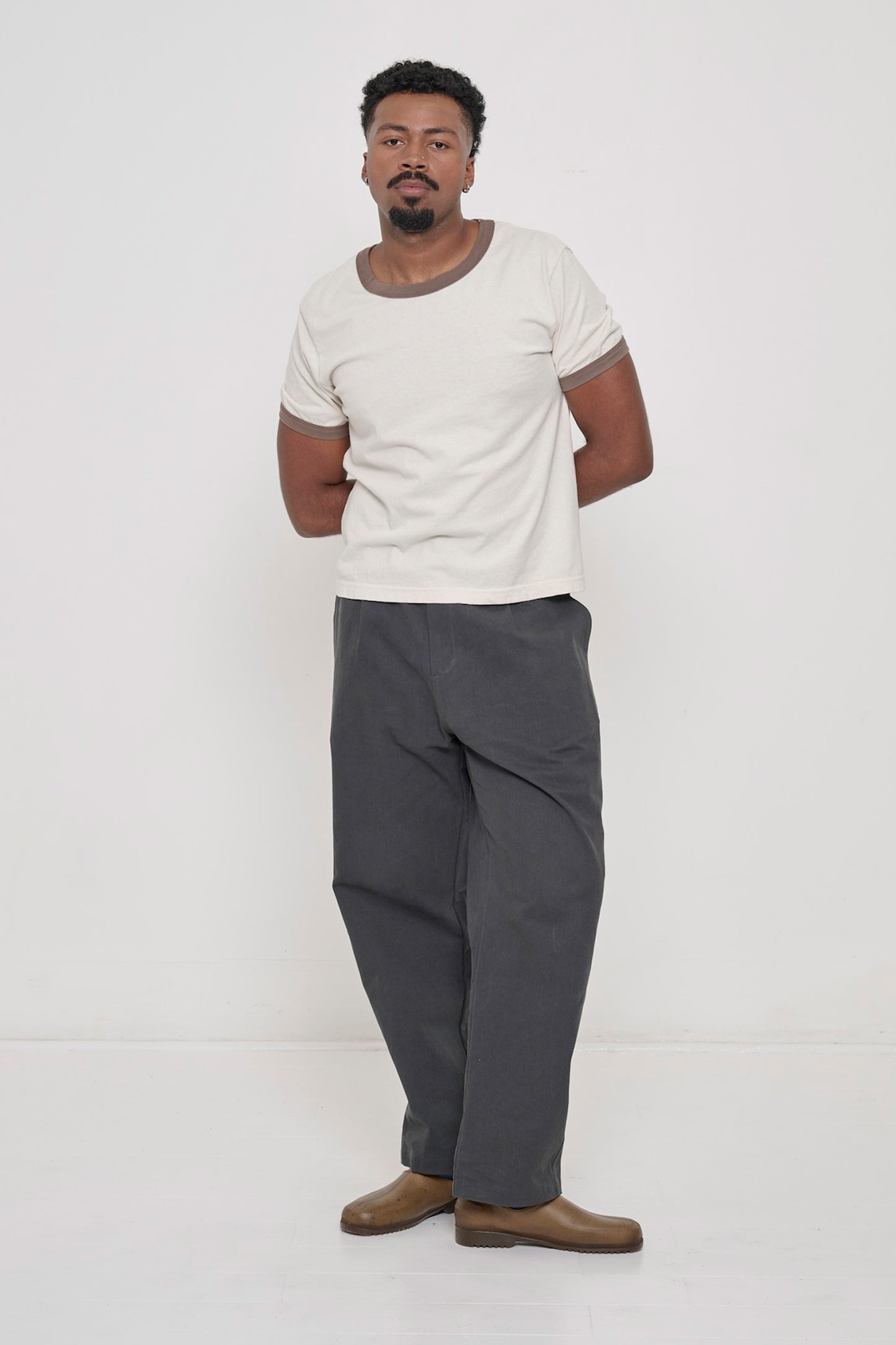Full length view of a 6'2" tall man, wearing Slate Cotton Twill Life Uniform Pants, hem just below the ankle.