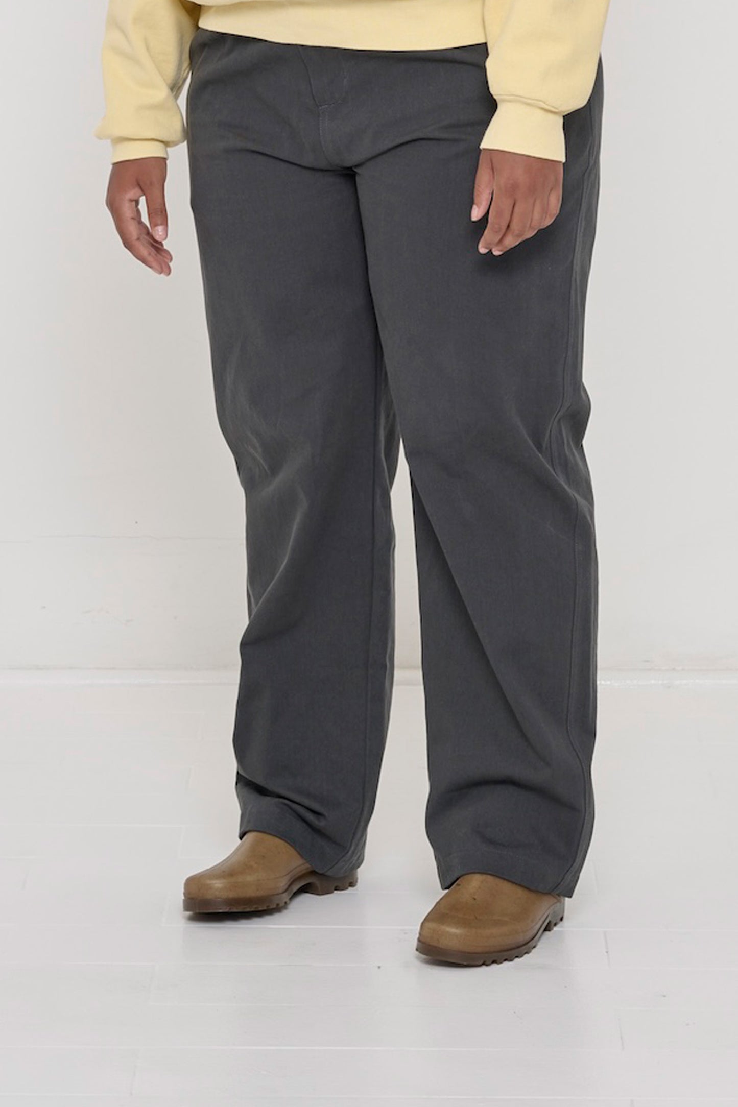 Bottom half of a person turned  45-degrees, in Slate Cotton Twill Life Uniform Pants, showing the inseam and outseam.