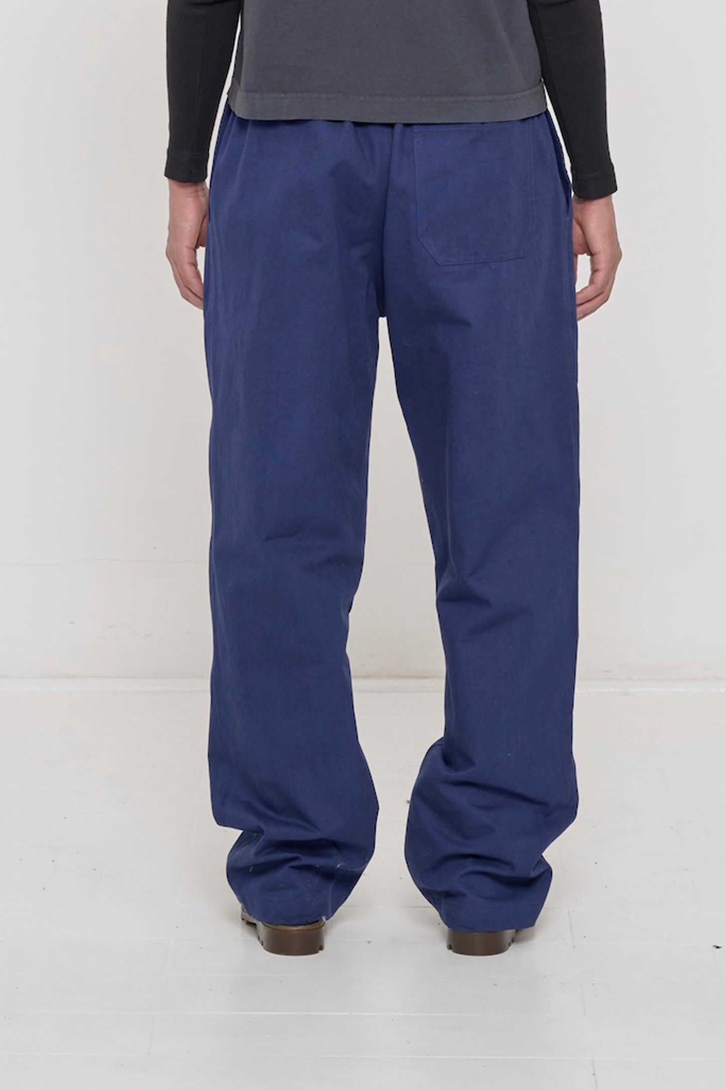 Back view: person in Washed Navy Cotton Twill Life Uniform Pants, revealing a back pocket.