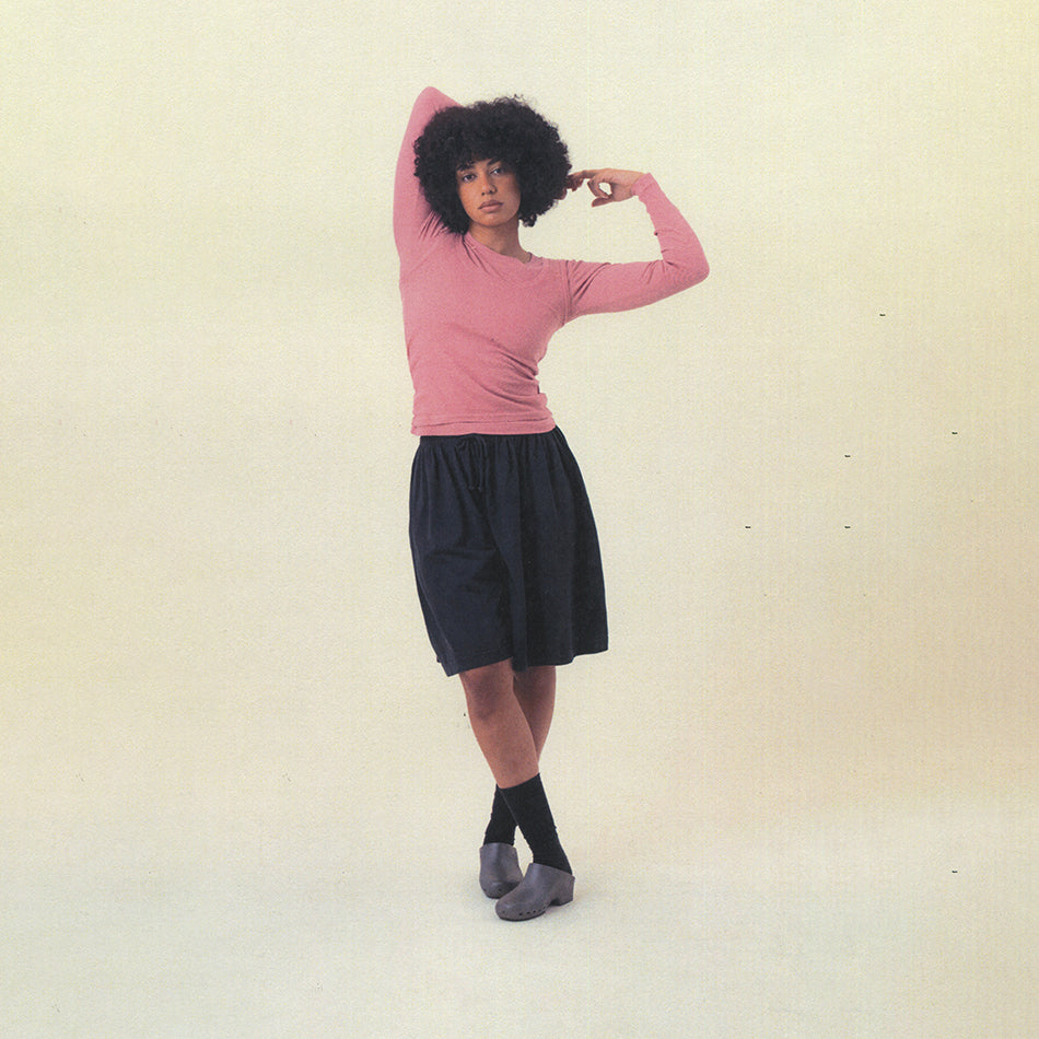Person wearing the Rib Long Sleeve in Wild Rose and Long Tubular Shorts in Slate on a plain background.