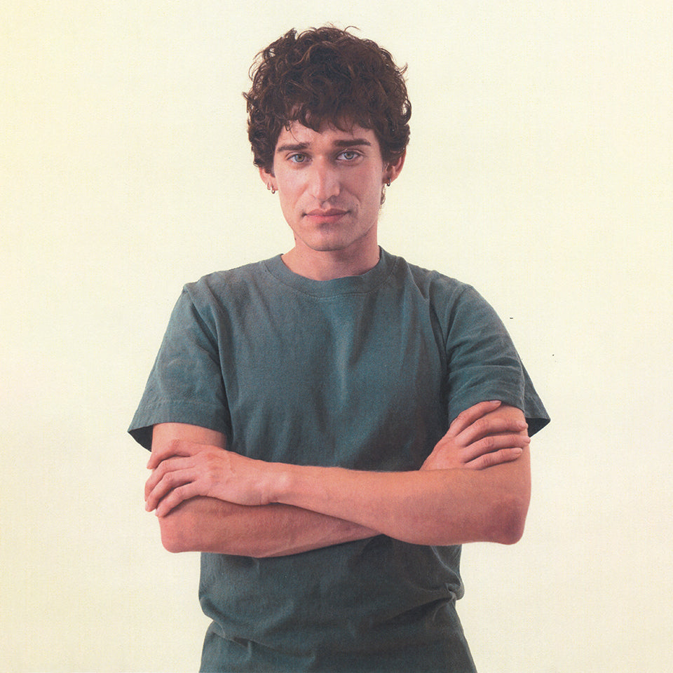 Person standing with their arms crossed, wearing the Short Sleeve Trash Tee in Pine.