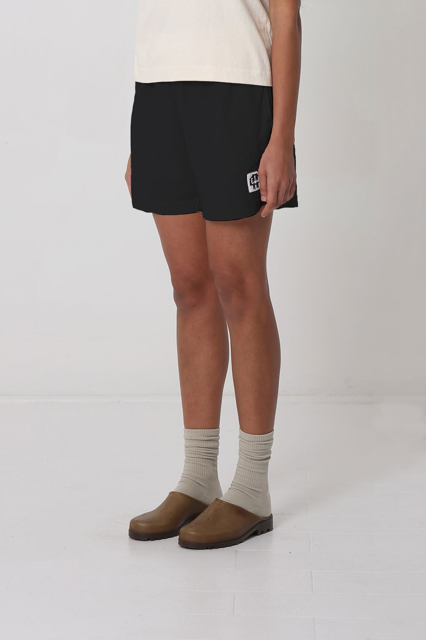 Waist down 3/4 front view, highlighting black and white logo.