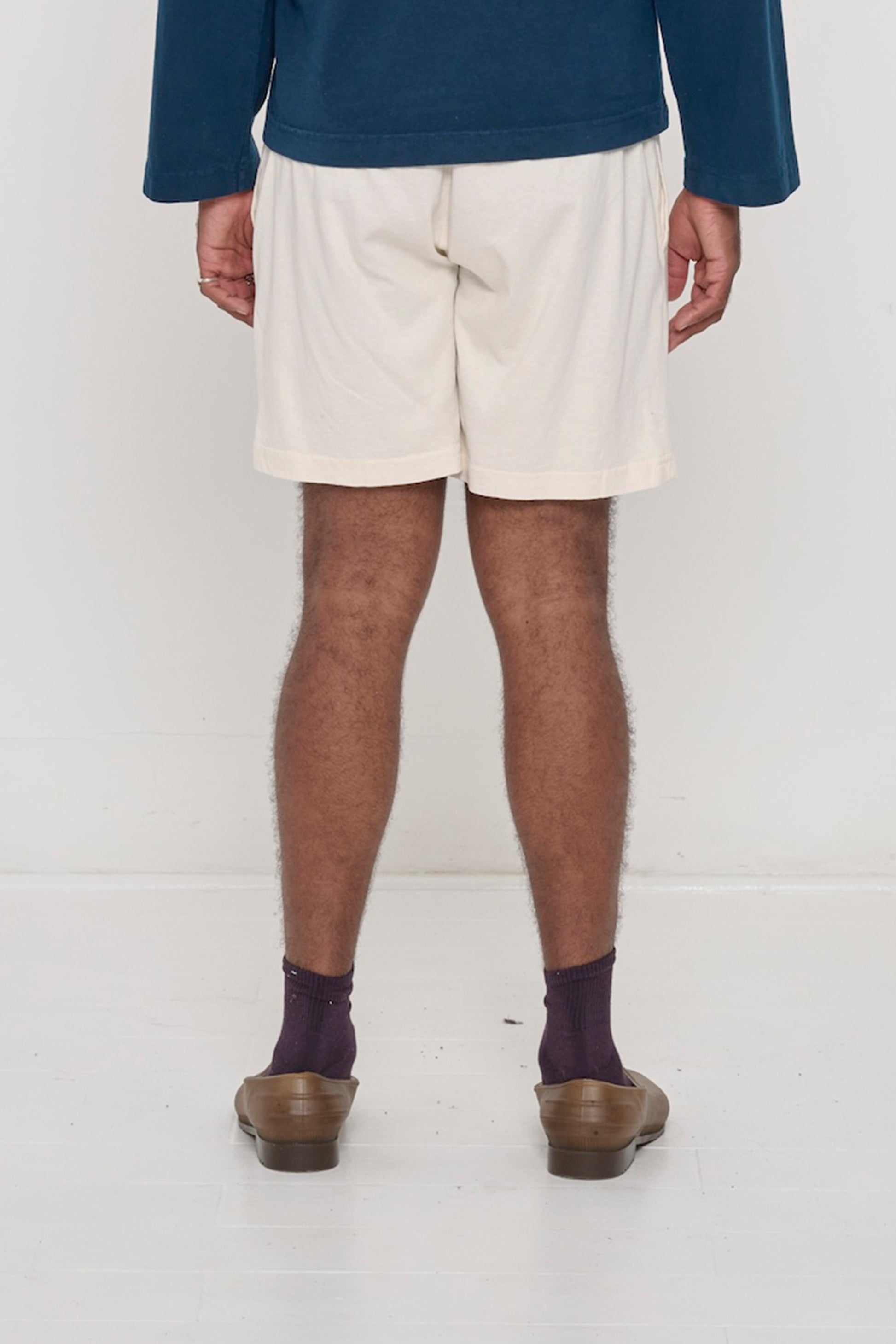 Back view: Scour Everyday Shorts on a person, waist down, showing relaxed fit.