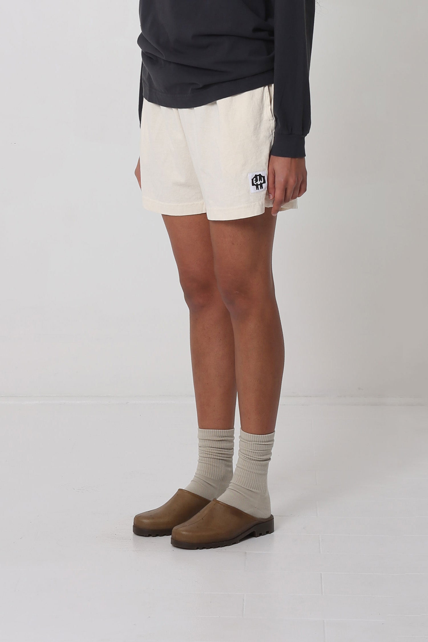 Waist down 3/4 front view, highlighting black and white logo.