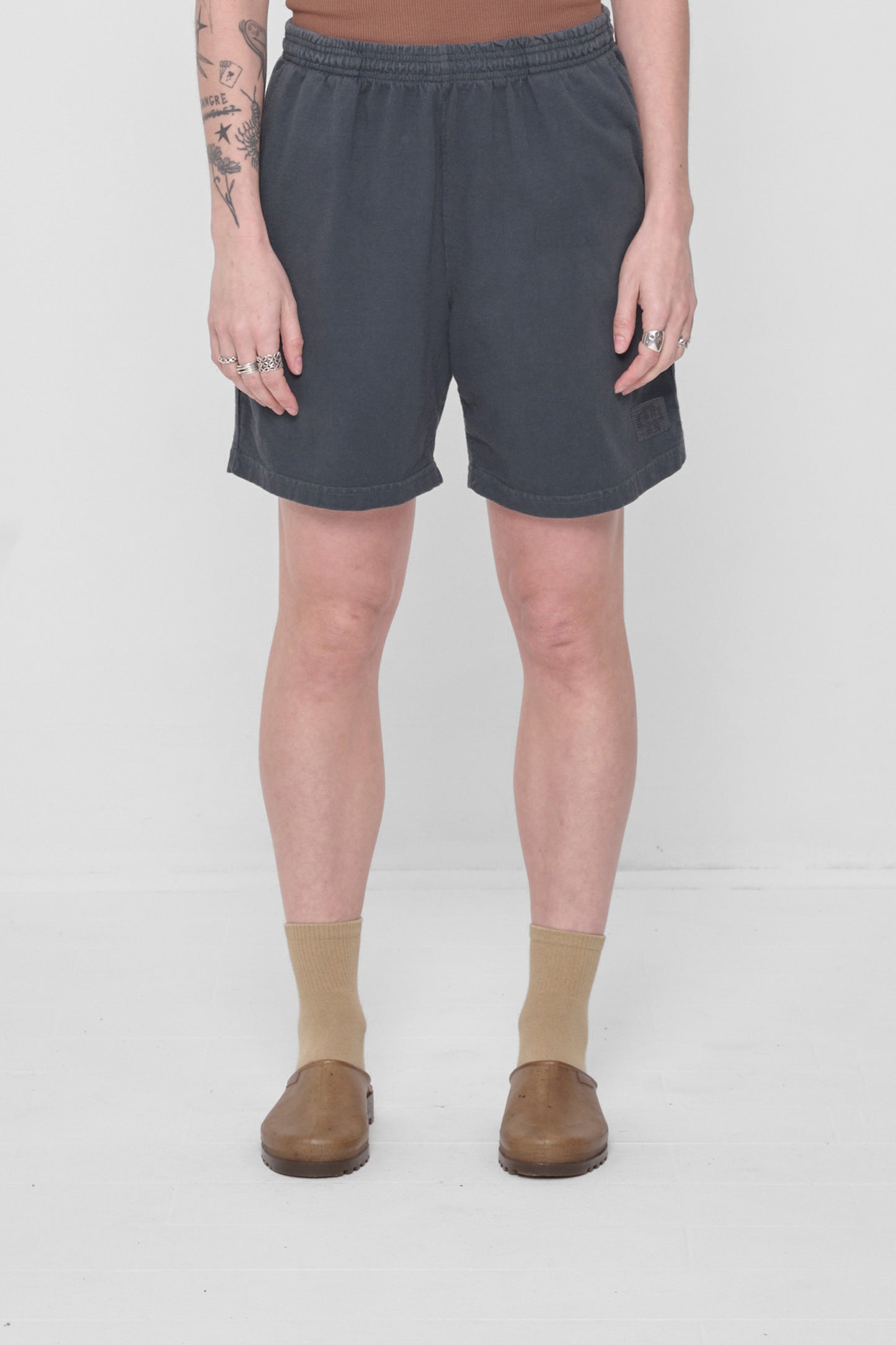 5'6" woman wearing size M Slate Everyday Shorts. Leg hem hits he at mid thigh. 