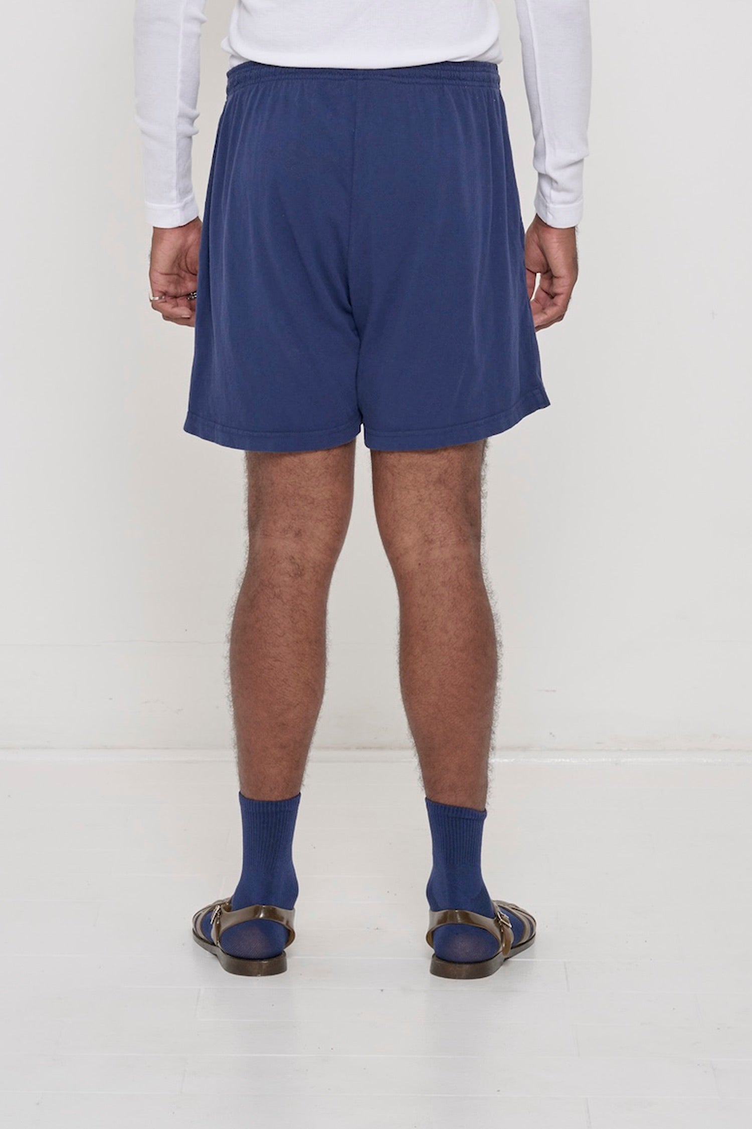 Close-up back view of Washed Navy Everyday Shorts on man. Highlights jersey fabric texture and elastic waistband.
