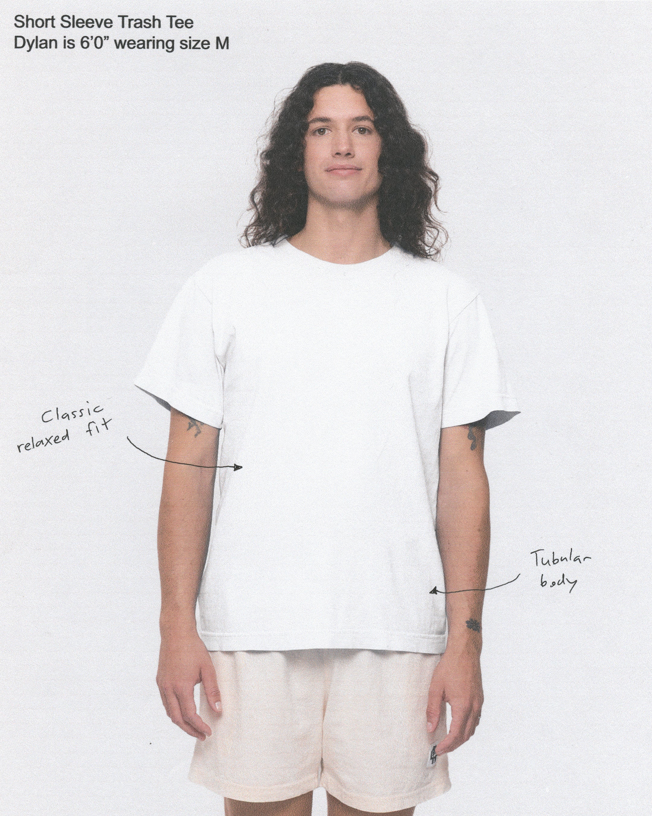 Photo of model wearing a white t-shirt, with annotated notes of clothing details.