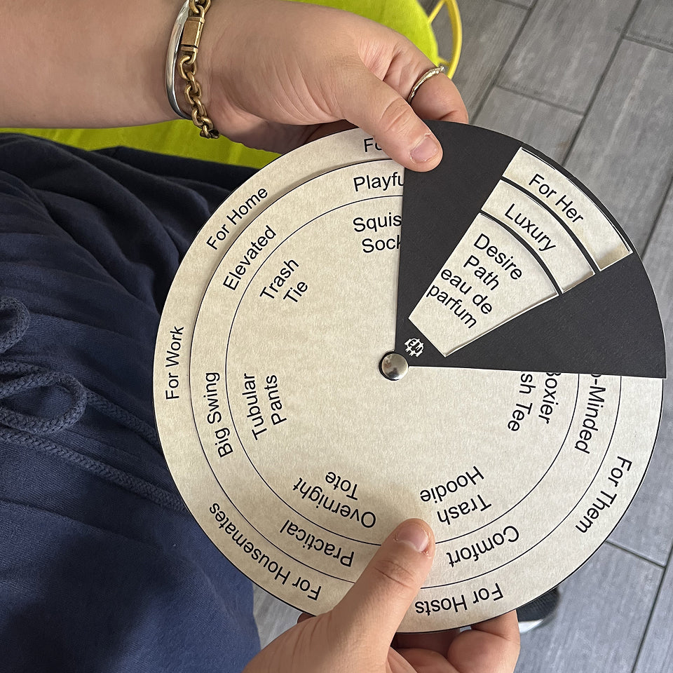 Person holding a circular selection tool with text on it, landing on "For Her, Luxury, Desire Path eau de parfum".