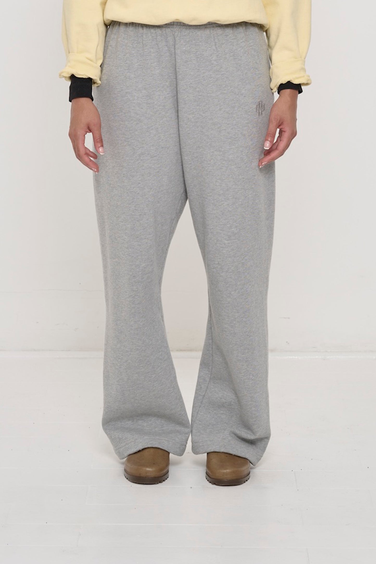 Front view: 5'8" person sized up in size L Heather Sweatpants, relaxed fit, slight bunching at the ankles.