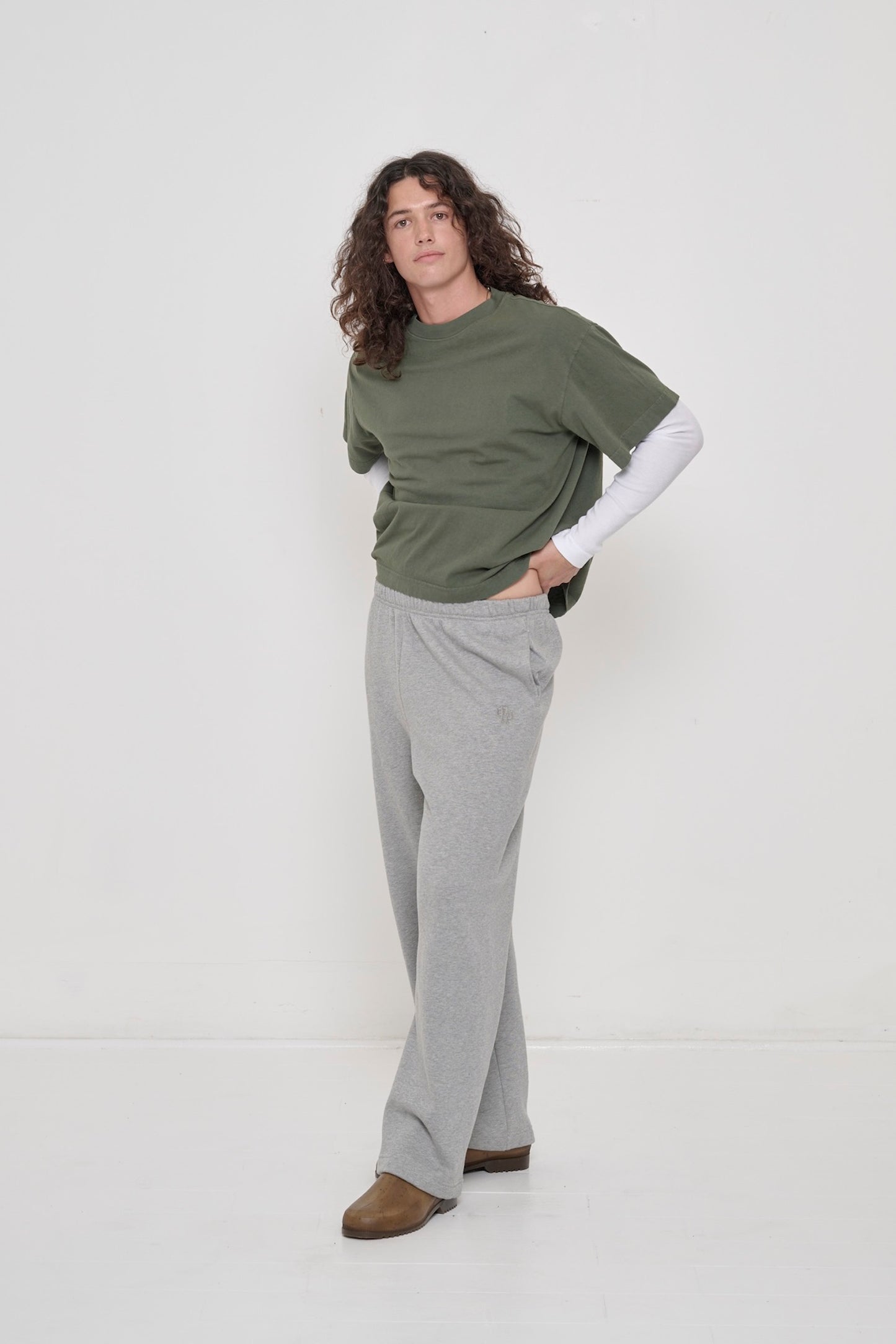 Person in Heather Sweatpants and a Pine Boxier Trash Tee, showcasing relaxed fit and soft fabric movement.