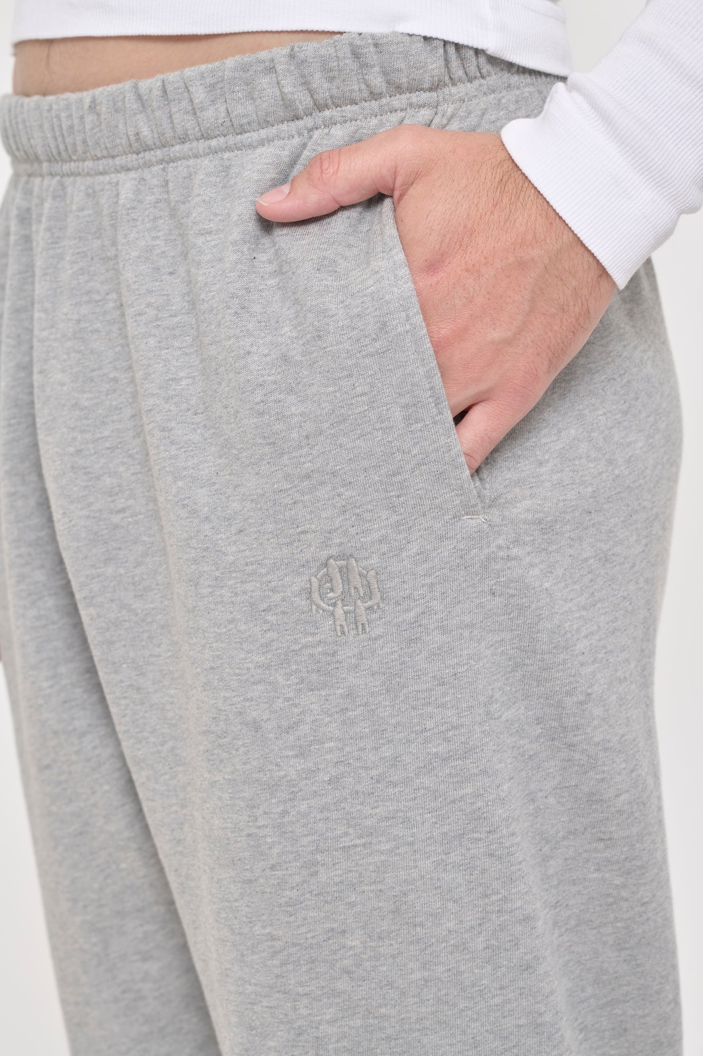 Heather Sweatpants side pocket with tonal "Bucky" logo embroidery, which shows 6 people holding hands with E.W in negative space.