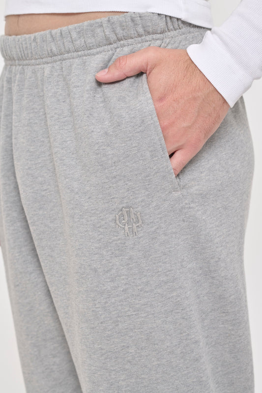 Heather Sweatpants side pocket with tonal "Bucky" logo embroidery, which shows 6 people holding hands with E.W in negative space.
